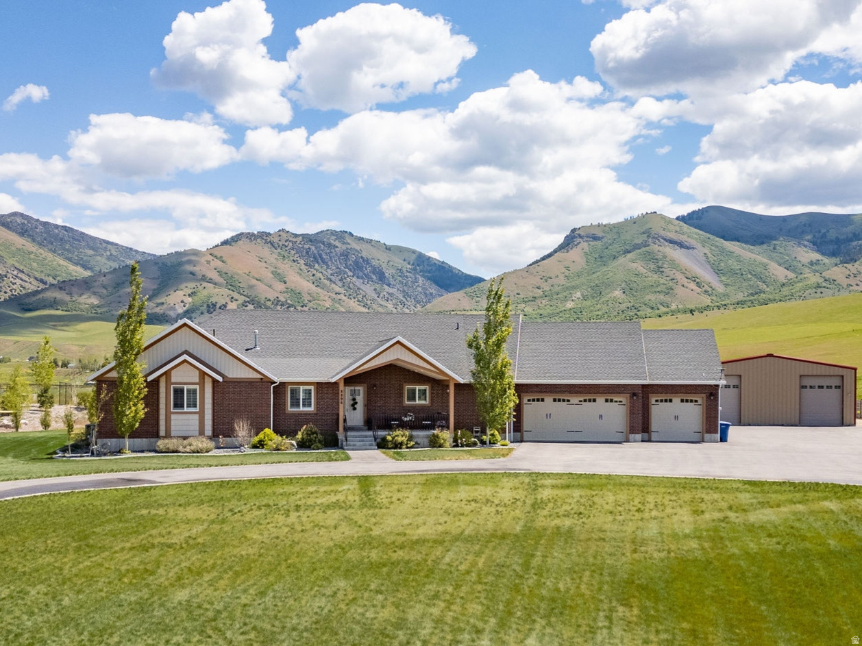 Tucked away on a private road, this custom-built, 4-bedroom, 3.5-bath home is situated on 2.76 serene acres with sweeping mountain views. The versatile, open floor plan is designed for modern living, featuring oversized bedrooms and expansive spaces throughout. The basement includes two generous flex spaces ideal for a home gym and year-round entertaining. The spacious kitchen boasts abundant cabinetry, a huge walk-in pantry, a large kitchen island with seating, and a dedicated dining space. For added comfort, a whole-house water filtration system and a reverse osmosis filter in kitchen ensure pure water throughout the home. Outside, the property features a 40-by-60 steel workshop with power offering endless possibilities. Come see this exceptional property!  Buyer to verify all information.