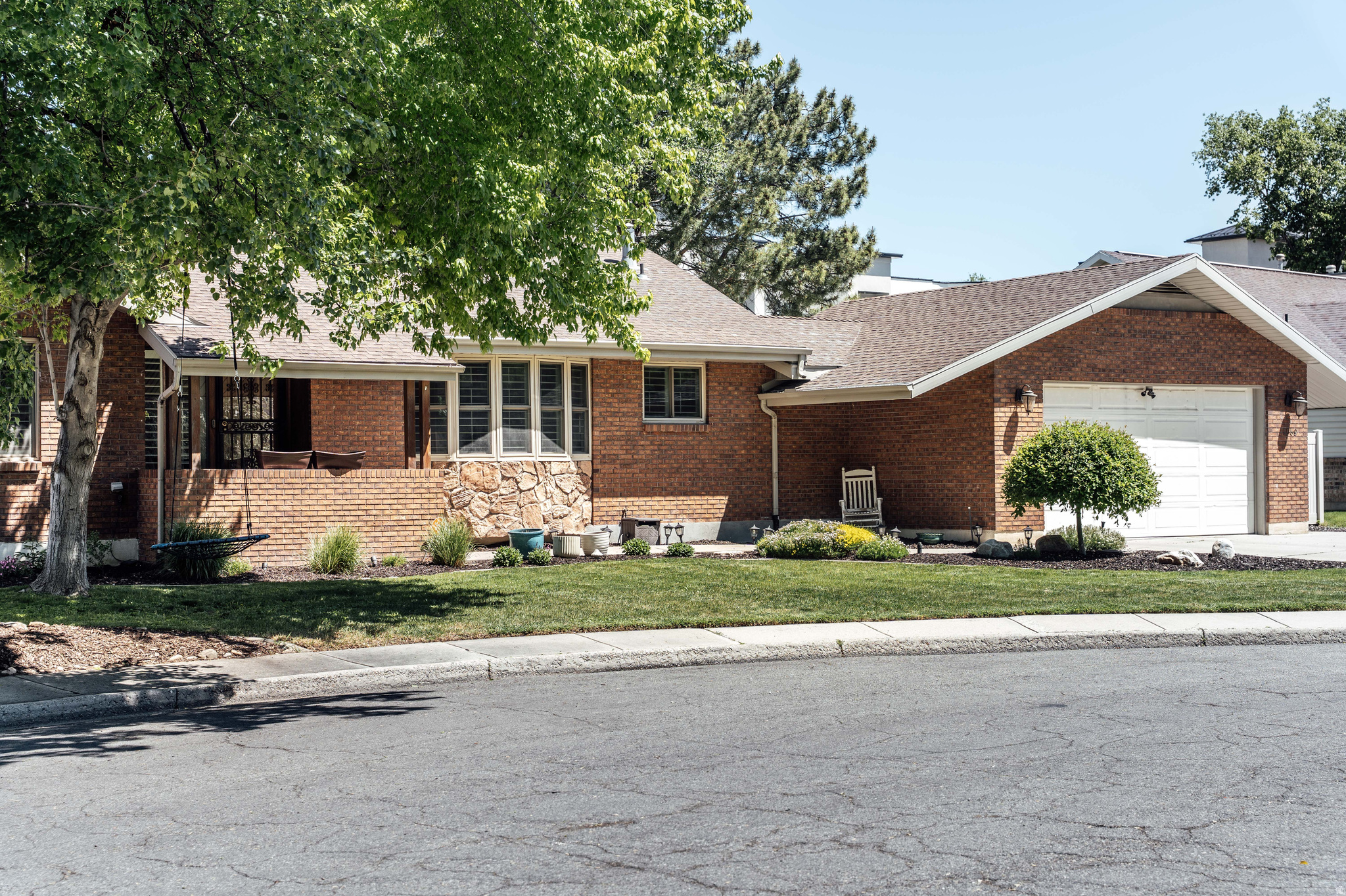 Tucked quietly at the end of a secluded cul-de-sac, just moments from the vibrant shops, cafs, and dining spots of Cottonwood Heights' Union Park, this unique rambler strikes a rare balance between timeless charm and effortless livability. Equal parts refined and relaxed, the home leans into a warm, collected aesthetic where layered textures, thoughtful finishes, and inviting gathering spaces create a feeling that is both eclectic and entirely livable. The main level unfolds with an organic, free-flowing layout that feels distinctly intentional without sacrificing comfort. An oversized kitchen island anchors the heart of the home, while clean white cabinetry, timeless tile finishes, and a perfectly framed sink window lend softness and understated charm. Multiple living and dining spaces offer room to gather, entertain, or simply settle in, each one connected by a natural sense of flow and light. Down the hall, a well-sized primary suite offers a quiet retreat complete with a generous walk-in closet. A spacious secondary bedroom and additional full bath provide flexibility for guests, family, or a thoughtfully tucked-away office space. The fully finished walk-out basement expands the home's versatility in all the right ways. A striking fireplace grounds the spacious family room, while the wet bar brings an entertaining edge to the lower level. A flexible fifth bedroom with private exterior access and a custom built-in Murphy bed creates the perfect setup for guests, creative work, or work-from-home living space. Two additional oversized bedrooms, generous closet space, and abundant storage round out the lower level with both comfort and practicality. Outside, the grounds feel intentionally designed for both connection and calm. A wraparound balcony, expansive patio, curated landscaping and dedicated fire pit area create a backyard equally suited for lively summer evenings or slow mornings spent with coffee in hand. Information is deemed reliable but not guaranteed. Buyers and agents should verify all details.