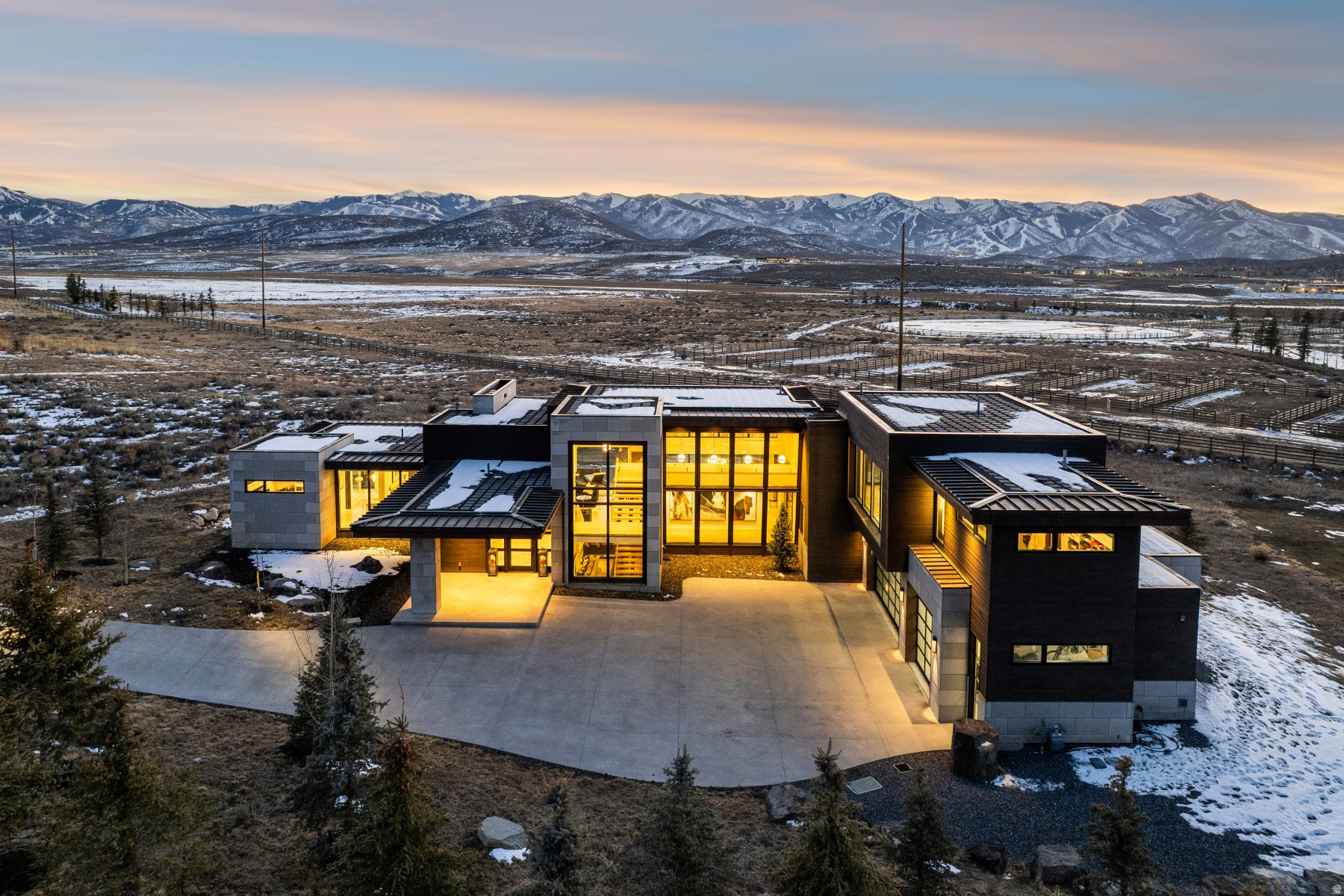 Architectural Masterpiece by Upwall Design with Full Membership  -- A highly coveted Full Promontory Club Membership is available with this property, offering immediate access to all club amenities. Panoramic views headline this contemporary architectural masterpiece designed by award-winning architect Michael Upwall and built by Yukon Construction. Floor-to-ceiling glass and a retractable wall system flood the home with natural light and open to approximately 1,400 square feet of expansive decking-creating effortless indoor-outdoor living and exceptional entertaining space. Situated in the convenient Palisades neighborhood of Promontory, just inside the equestrian gate, this home delivers dramatic vistas without sacrificing proximity to world-class amenities. Offering five bedrooms, eight bathrooms, a spacious office, and private gym, the residence is thoughtfully designed with elevated finishes throughout. All bedrooms are ensuite, including three luxurious primary suites: a main-level suite with unobstructed views, a lower-level suite ideal for guests, and a grand primary retreat occupying its own private level with a spa-like sanctuary. Designed for entertaining, the garden level features an additional living area, well-appointed bar, 1,200 square foot covered patio, and three ensuite guest suites. A large finished bonus space includes a dual office, generous home gym, and dedicated storage. Ownership is further enhanced by Centriq, a state-of-the-art home management system. In the Palisades neighborhood, owners are closest to the resorts, rewarding families with not only the easiest access to all of town's dining and shopping convenience, but also the most vibrant and up close views of the Wasatch mountain range. Inside the gates, enjoy nearby access to golf courses, clubhouses, dining, spa, fitness centers, pools, tennis, pickleball, ice skating, the Shed, Kids Cabin, Equestrian Center, and Alpine Lodges at Deer Valley and Park City Mountain.