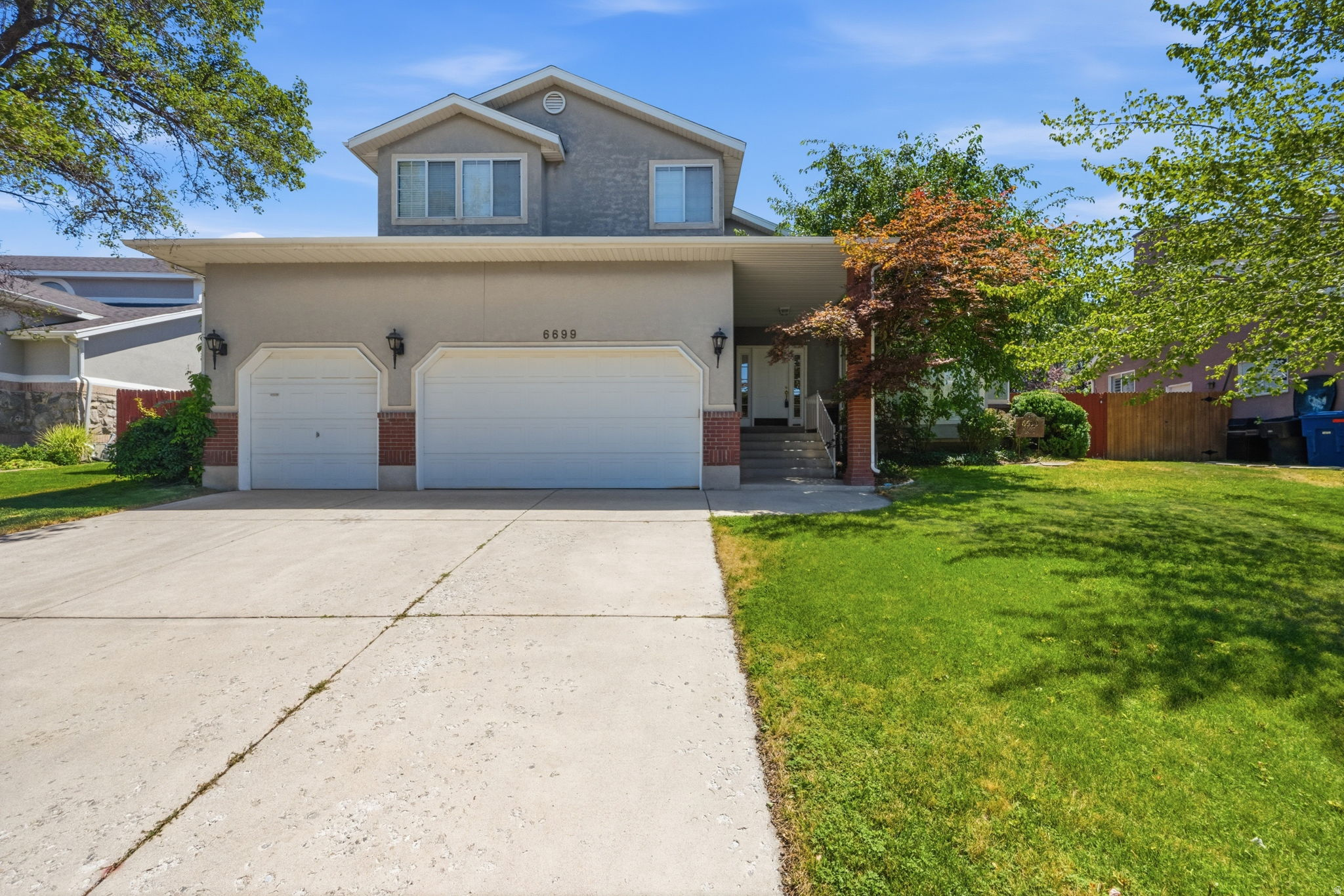 Desirable Mill Hollow Estates in Cottonwood Hts. close to great schools, shopping, world class ski resorts, hiking, biking, golfing all you could ask for & more. Enter from the large front porch through the wide entry door & witness the Formal living & dining rooms with vaulted ceilings & bay window. The kitchen features a large pantry, gas range, dining area and breakfast bar. The adjoining great room has high ceilings, gas fireplace & built-ins, an Atrium door from the great room accesses the patio & good sized backyard with shed. Opposite side of the great room is your 1/2 bath & laundry & entry to the 3 car garage. The basement offers a family room, bedroom & 3/4 bath. A wide staircase leads you upstairs where 3 large bedrooms & 2 full baths are found. The primary bedroom features a walk-in closet, bay window, vaulted ceiling, ensuite bath with separate jet tub & shower & large vanity with double sinks. Heating & cooling system  new in 2025. Opportunity to personalize a home in an upper end area.