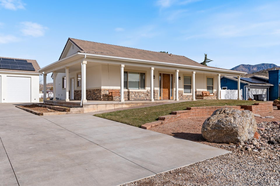 SELLER FINANCING OPPORTUNITY - 20% down and take over seller's payments. Seller Motivated. Turnkey 4,000 sq ft home on a full acre. 5 beds, 4.5 baths, remodeled kitchen with custom built-ins. Walk-out basement with its own kitchen, laundry, massive rec room, and separate entrance. Perfect for multigenerational living, rental income, or your own private retreat. Paid solar averages $12/month, community well benefits, and backup power systems keep operating costs low while you build equity in one of Southern Utah's best neighborhoods. A true gem. Outside: 19 mature fruit trees, 30x40 shop with hoist and bathroom, splash pad, gardens, full wraparound asphalt drive, horse and animal rights, storage for days. 2 minutes to Snow Canyon, 12 minutes to town. Cooler temps, dark skies. The Bottom Line: Seller financing meets exceptional property. While others wait for perfect conditions, you can buy now, turnkey ready, every detail in place!