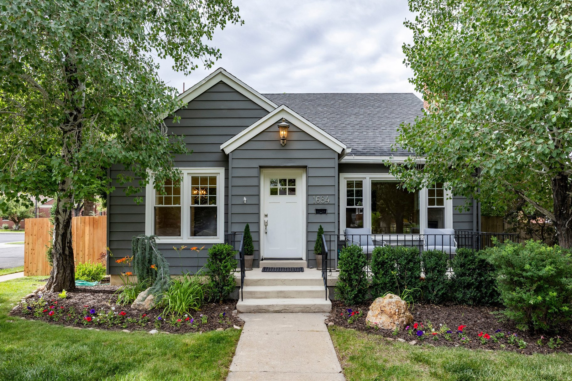 Nestled on a quiet, tree-lined street in the heart of Yalecrest, this charming bungalow offers timeless character, thoughtful updates, and an exceptional lifestyle in one of Salt Lake City's most coveted neighborhoods. Positioned on an oversized corner lot, the home welcomes with beautiful curb appeal, mature landscaping, and a darling front porch that sets the tone for what awaits inside.Rich in architectural charm, the interior features original hardwood floors, graceful arched doorways, and new windows that flood the home with natural light. The generous living room seamlessly connects to a spacious dining area, creating an inviting environment for both everyday living and entertaining. The updated kitchen offers excellent storage, glass-front cabinetry, stainless steel appliances, and beautiful mountain views.The main level includes two spacious bedrooms and a classic full bath accented by timeless black-and-white tile. The lower level provides tremendous flexibility with new carpet, abundant storage, a large family room, laundry area, guest suite and a second non-conforming bedroom ideal as an office, playroom, guest space, gym, or hobby room, and an additional full bath.Outside, the backyard serves as a private retreat featuring brand new wood fencing, a covered patio, multiple gathering spaces, lush lawn areas, and a detached one-car garage. Conveniently located near the University of Utah, downtown Salt Lake City, nearby trails and recreation, neighborhood parks, local dining, boutique shopping, and Salt Lake International Airport, this walkable Yalecrest residence offers an extraordinary opportunity to enjoy one of the city's most beloved neighborhoods.