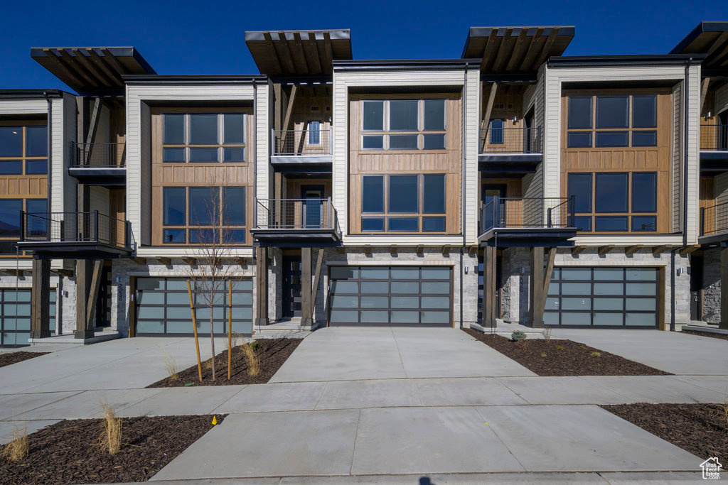 Discover The Pointe at Current-where sleek modern design meets the fresh energy of mountain living. Nestled between Park City and Heber City, this thoughtfully designed townhome sits along the western edge of Jordanelle Reservoir, offering a beautiful blend of style, efficiency, and year-round adventure.  As the seasons shift, step outside to blooming trails, crisp mountain air, and endless outdoor recreation-from hiking and biking to world-class skiing just minutes away. Enjoy easy lake days and effortless access to Deer Valley Resort through a private underpass beneath SR-450-making every getaway feel close to home.  Built to Garbett Homes' Efficiency+ standards, this home is designed to feel as good as it looks. With advanced insulation, Solar-E windows, and an energy recirculation system, you'll enjoy abundant natural light, balanced temperatures, and lower utility costs all year long.  Inside, the space feels fresh and elevated with quartz countertops, custom cabinetry, and durable, high-performance flooring. Step out onto your private balcony to take in sweeping mountain views, or unwind upstairs in one of two spacious primary suites-each offering its own peaceful retreat. The grand suite even features a private deck, perfect for soaking in sunny spring mornings or cool alpine evenings.  With no HOA restrictions on nightly rentals, this home offers incredible flexibility-whether you're looking for a full-time residence, a seasonal escape, or a smart investment.  Ask about current buyer incentives available through our preferred lender and come experience summer at The Pointe at Current