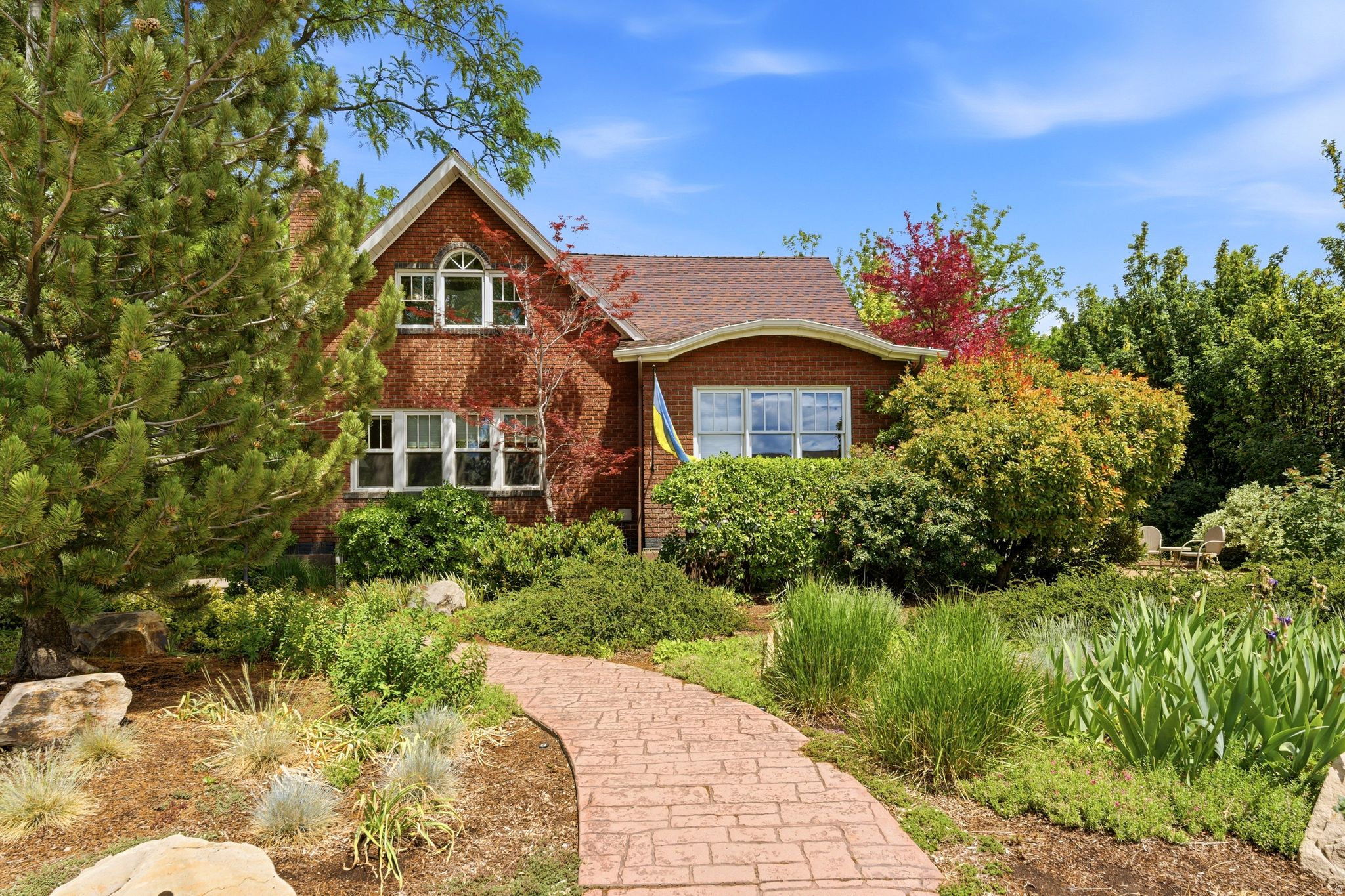 One of the first Arts and Crafts carriage homes built in the Sugar House / 9th & 9th area. Architect-designed with exceptional craftsmanship, featuring original quarter-sawn oak doors and millwork throughout. Spacious, light-filled layout with seamless flow from living room to dining and kitchen. Includes 1,300 sq ft lower-level apartment with separate entrance and ground-level windows-ideal for extended family or guests. Large outdoor deck overlooks mature, professionally landscaped yard with mature trees and perennials offering privacy and seasonal beauty. Extensively renovated: new electrical, plumbing, insulation, structural upgrades including earthquake stabilization. Endless pool swim/spa located off back deck is included. Walk to University of Utah, Rowland Hall, Judge Memorial, McGillis School, parks, restaurants, and shopping. Quiet street with strong neighborhood community. Move-in ready with potential for solar and future enhancements. Rare opportunity to own a piece of architectural history with modern systems and prime location.  Square footage figures are provided as a courtesy estimate only.  Buyer is advised to obtain an independent measurement.