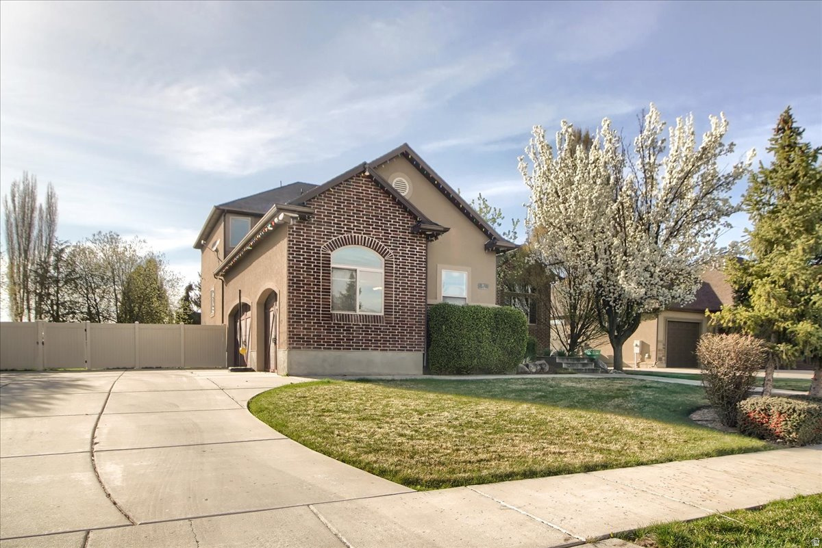 Built as a Model Home, this 2-story Neo-traditional home was built to shine.  The floor plan and design were built top of the line featuring a main level master suite, home office with built-in shelving, large great room off of kitchen area, spacious laundry room, sound system for the main floor, basement and deck, gas appliances and fireplace with 2 furnaces and 2 a/c units.  Vivint home security system installed and will remain with the house.   Mature landscaping with garden boxes, fruit producing shrubs, and fully fenced backyard.  Nestled in a quiet community with easy access to paved trails and parks nearby for walking/biking, etc.  Within minutes of the West Davis Corridor making shopping and commuting convenient.  Come and see this beautiful, well-maintained home and make it yours.