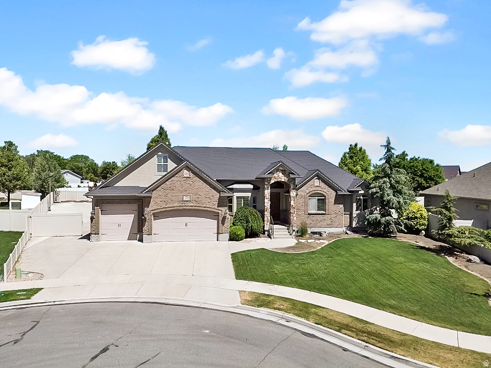 Experience the perfect blend of luxury, functionality, and outdoor living in this stunning 7 bedroom, 3.5 bath home. Thoughtfully designed for entertaining and everyday comfort, this property offers exceptional indoor and outdoor spaces you'll love coming home to. Step outside to your private backyard retreat featuring professionally designed landscaping, a fully equipped outdoor kitchen with a stainless steel grill and pizza oven, and a custom natural stone gas fire pit perfect for gathering with family and friends. A standout feature is the massive RV pad, offering exceptional space for RVs, trailers, boats, and all your recreational toys. Inside, the kitchen is the heart of the home, showcasing stainless steel appliances, a double oven, and an impressive island ideal for cooking, dining, and entertaining. The fully finished basement offers incredible flexibility with a second full kitchen, separate laundry area, fireplace with thermostat controls, custom barn doors, built in bookcases, an adorable playroom, and a dedicated theater room designed for the ultimate movie night experience. Complete with a 4 car garage featuring custom overhead storage and a 9-foot garage door, this home delivers the space, upgrades, and lifestyle today's buyers are searching for. This home in minutes from both The District and Mountain View Village.