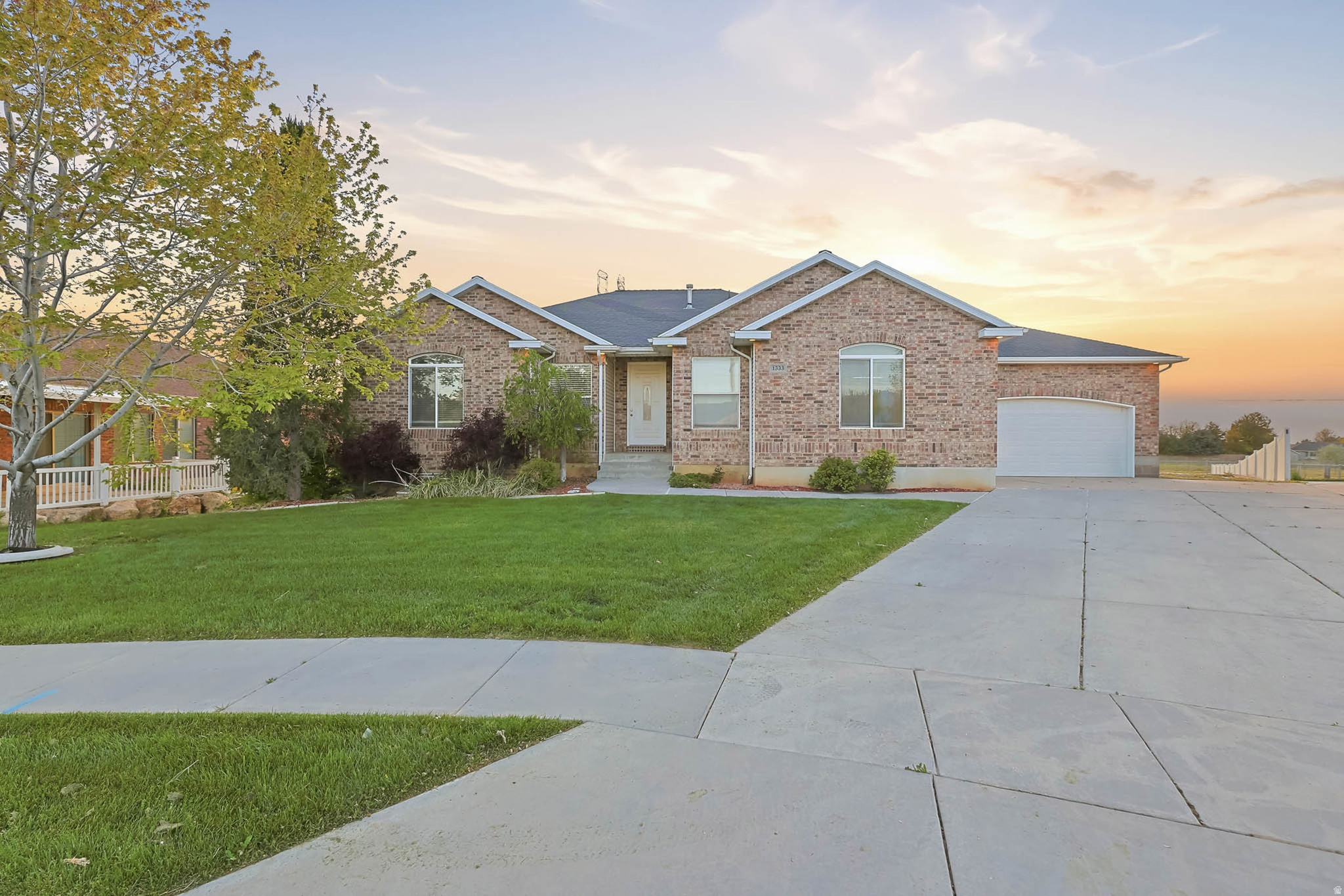 Price Reduced! Beautifully maintained ranch-style home on a quiet cul-de-sac in Clinton. From the moment you walk in, vaulted ceilings and real hardwood floors set the tone. This home is spacious, light-filled, and has a great open layout. The main floor flows beautifully from a large kitchen with granite countertops, stainless steel appliances, and a large island into a dining area wrapped in windows overlooking open fields. The living room features a cozy fireplace, and the entire back of the home connects to a fully conditioned sunroom, accessible from both the primary suite and living room adding incredible year-round living space with stunning backyard views. The primary suite features vaulted ceilings, a soaking tub, separate shower, and dual vanities. Two additional bedrooms, two full baths, a half bath, and main floor laundry complete the main level. The fully finished daylight basement adds a massive family room with sliding glass doors, three additional bedrooms, one with direct backyard walkout access, dedicated storage rooms, and tons of natural light. Large bonus room with connections for a possible future kitchen. Outside features a covered patio, space for the grill, and a large backyard that backs up to protected open land. Horses, goats, open fields, and sunsets with easy access to the driveway to park rv's/trailers. Three car garage, RV parking, and extra parking into the yard. All in a community that gives you small town charm with easy access to Ogden and Salt Lake City.    Square footage figures are provided as a courtesy estimate only.  Buyer is advised to obtain an independent measurement.
