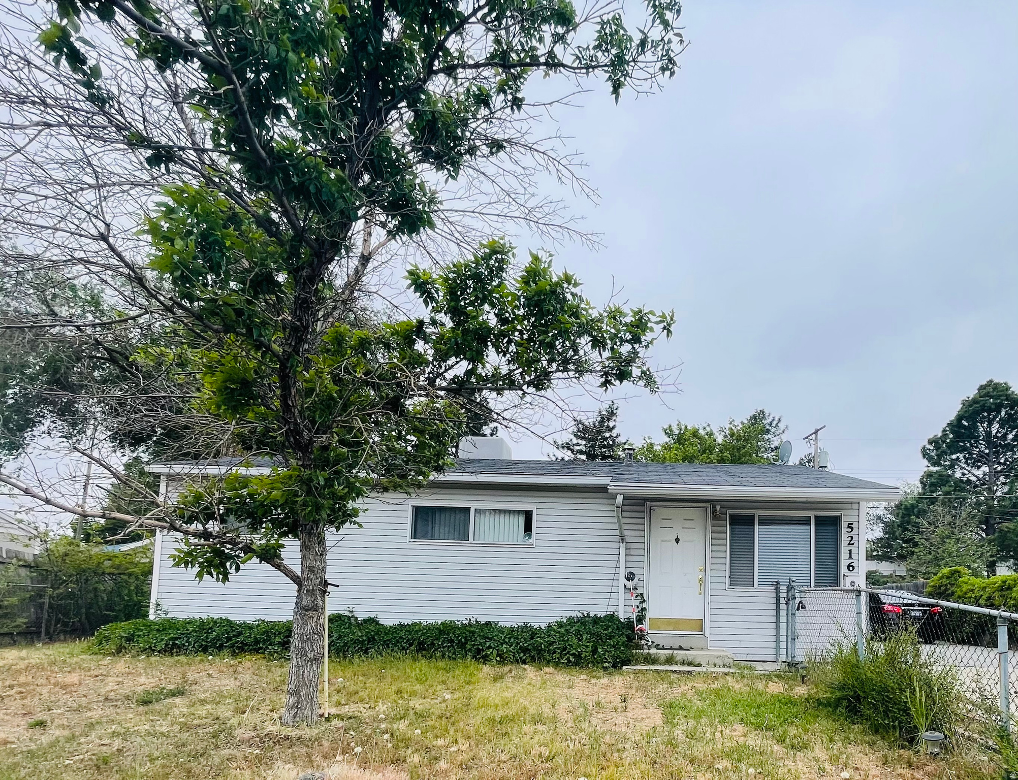 Single-story resedential home with light gray horizontal siding and dark shingle roof. The interior has hardwood flooring in the the bedrooms and living areas. The property includes a large concrete driveway (parking for 6-8 cars) witha metal carport and a fenced-in yard. Square footage figures are provided as a courtesy estimate only and were obtained from county records.  Buyer is advised to obtain an independent measurement. Please schdule your showing today!