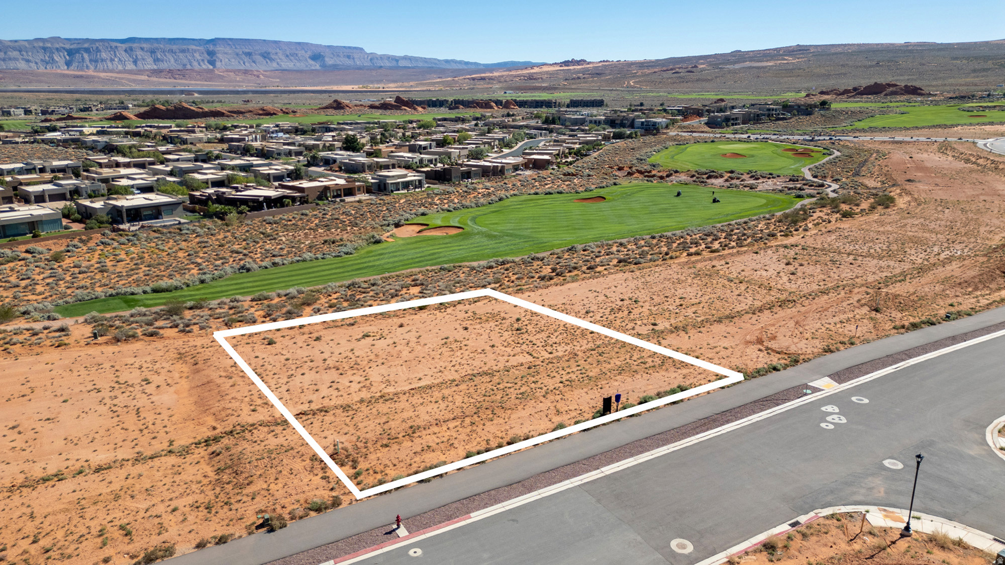 With over half an acre, this premium homesite offers an exceptional opportunity to build a custom dream home or luxury retreat, surrounded by panoramic views of the Red Rock Cliffs, Zion National Park, and Mollie's Nipple, and ideally positioned on Hole #17 within one of Southern Utah's most sought-after resort communities. Enjoy access to championship golf, off-road trails, and year-round recreation, all while maintaining a more private, upscale residential setting. What truly sets this lot apart is its quieter positioning--minimizing through traffic, reducing road noise, and limiting headlight intrusion--creating a more peaceful living experience compared to interior or main-road homesites. Protected view corridors preserve your long-term sightlines, adding both daily enjoyment and future resale value. Designed for a walk-out basement, this property allows for a smarter, more functional build, offering flexibility for additional living space, guest quarters, or seamless indoor-outdoor flow. A key advantage is the ability to build more efficiently--a 5,000 sq ft two-story home requires only a 2,500 sq ft footprint, leaving significantly more usable yard space than a traditional single-level design, with ample room for a pool, outdoor kitchen, entertaining areas, and expanded garage space for boats, RVs, or recreational vehicles. Up to $25,000 in preferred builder incentives may be available, depending on purchase terms--making this not just a homesite, but a strategic opportunity to build smarter and live better in Southern Utah. Ask the agent about preferred builder. More... where world-class design and luxury meets the adventure and natural beauty of Southern Utah. Minutes from Sand Hollow Reservoir, Zion National Park, and endless outdoor recreation, this is more than just a place to live it's a place to experience your legacy. Seller has conceptual floor plans and renderings that can be included in the cost of the lot.