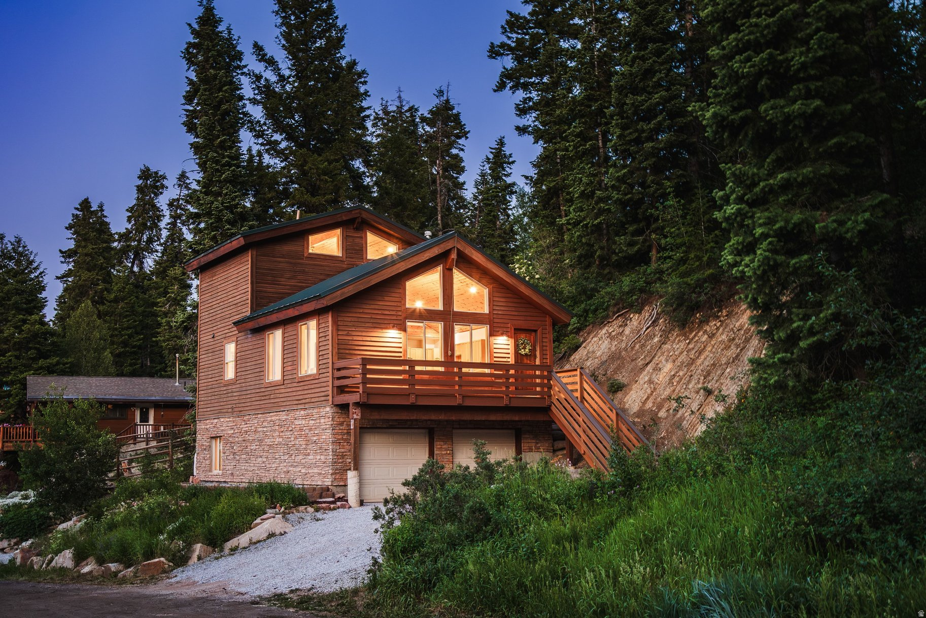 Nestled among towering evergreens in the Summit Park community, this updated mountain home offers the perfect balance of privacy, character, and convenience-just minutes from Park City and an easy drive to Salt Lake City. Tongue-and-groove vaulted ceilings, picture windows, and warm natural wood finishes create a bright, inviting living space filled with natural light. The open floor plan features spacious gathering areas, generously sized bedrooms, granite countertops, and a functional layout designed for both full-time living and weekend getaways. The lower level includes a separate exterior entrance, providing flexibility for guests, multi-generational living, a private home office, or additional living space. Outside, enjoy the peaceful mountain setting surrounded by mature pines with nearby hiking and biking trails. A metal roof, cedar exterior, attached two-car garage, and move-in-ready condition make this home as practical as it is inviting. Whether you're looking for a primary residence, mountain retreat, or investment property, this home offers the space, flexibility, and location that make Summit Park one of Park City's most desirable mountain communities.