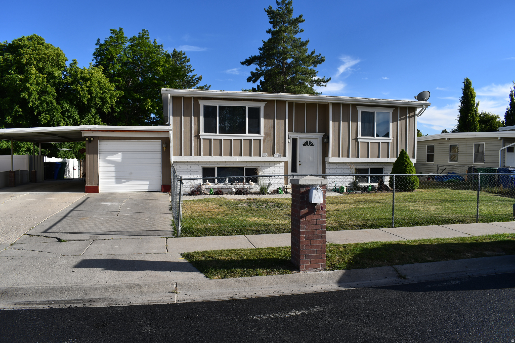 Welcome to this well-maintained split-entry home in one of West Jordan's most desirable and convenient locations! Offering 4 bedrooms and 2 bathrooms, this property features a fully equipped mother-in-law apartment, making it ideal for multi-generational living or potential rental income. The home has been exceptionally cared for and showcases durable tile flooring, a functional layout, and plenty of natural light throughout. Step outside to enjoy a spacious patio, a private backyard perfect for entertaining, and the convenience of a covered carport. The durable PVC roof provides added value and peace of mind. Located in a quiet, established neighborhood with easy access to schools, shopping, parks, and major commuter routes, this home combines comfort, versatility, and an unbeatable location. Whether you're looking for a primary residence or an investment opportunity, this West Jordan gem is one you won't want to miss!  Square footage figures are provided as a courtesy estimate only and were obtained from county records.  Buyer is advised to obtain an independent measurement.