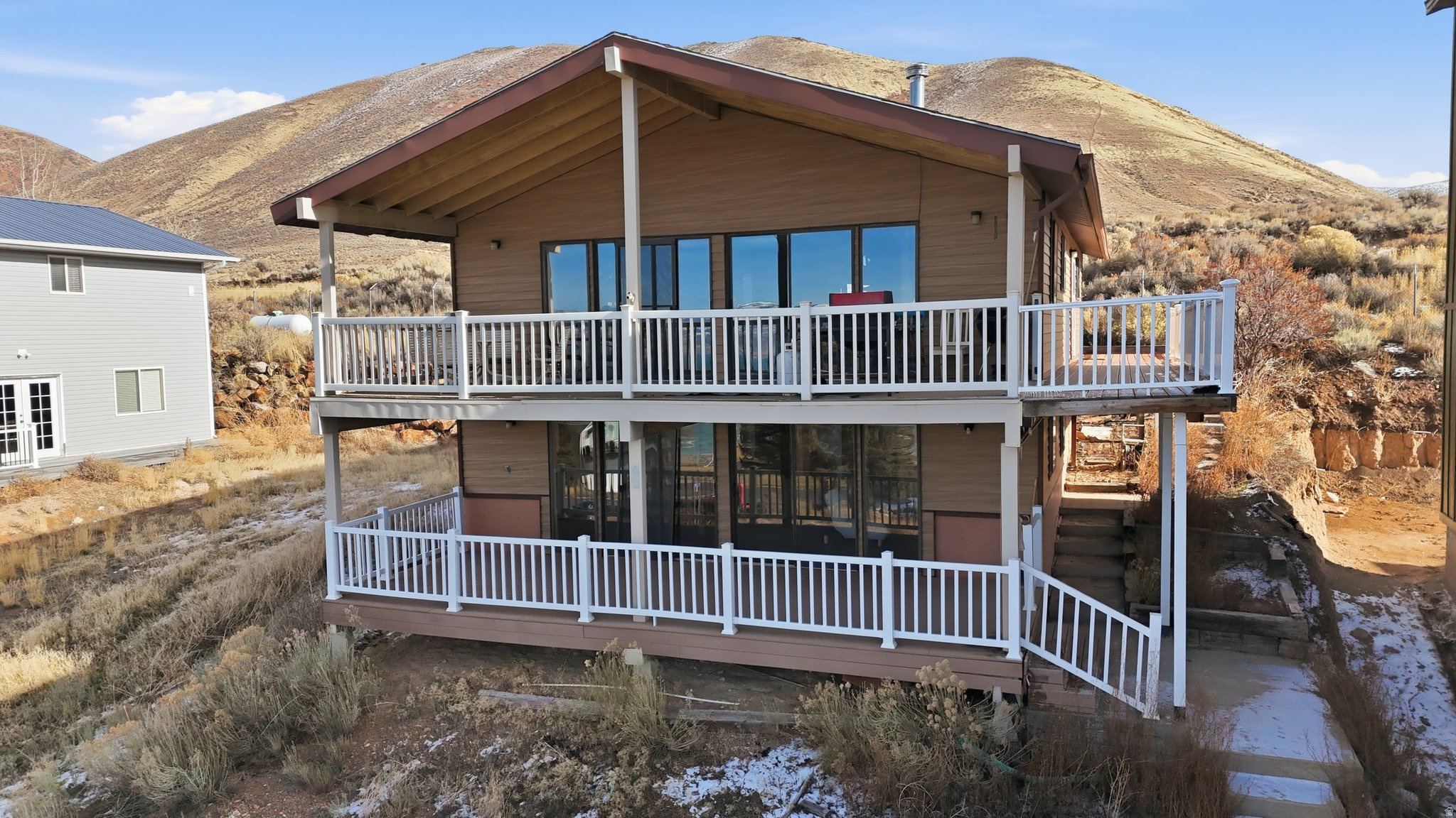 Welcome to your Bear Lake retreat in the coveted East Shore Subdivision of Saint Charles, Idaho! This awesome getaway offers the perfect blend of recreation, comfort, and year-round living. Enjoy a gated community with incredible HOA amenities including pickleball courts, biking and hiking trails, and a semi-private beach with easy access to East Shore Marina for effortless boat and watercraft docking. All of this for a low $75/month HOA fee! The home features 4 bedrooms and 2 bathrooms with brand-new LVP flooring throughout, creating a fresh, clean, and modern feel. Cozy up by the wood-burning fireplace after a day on the lake, and enjoy the convenience of having the washer, dryer, refrigerator, microwave, and wood stove all included. Step outside to two covered deck spaces, perfect for outdoor dining, picnics, or simply soaking up the Bear Lake sunshine. Whether you're looking for a peaceful vacation escape, an investment property, or a full-time residence, this home delivers. Bear Lake is a year-round playground offering boating, hiking, biking, pickleball, and endless outdoor adventure. This is your chance to own the perfect retreat in one of the most desirable communities on the east shore! No short term rentals allowed.  Buyer to verify all Information.  Don't forget to click the tour link in the listing to view the video tour and the 3D Matterport tour!