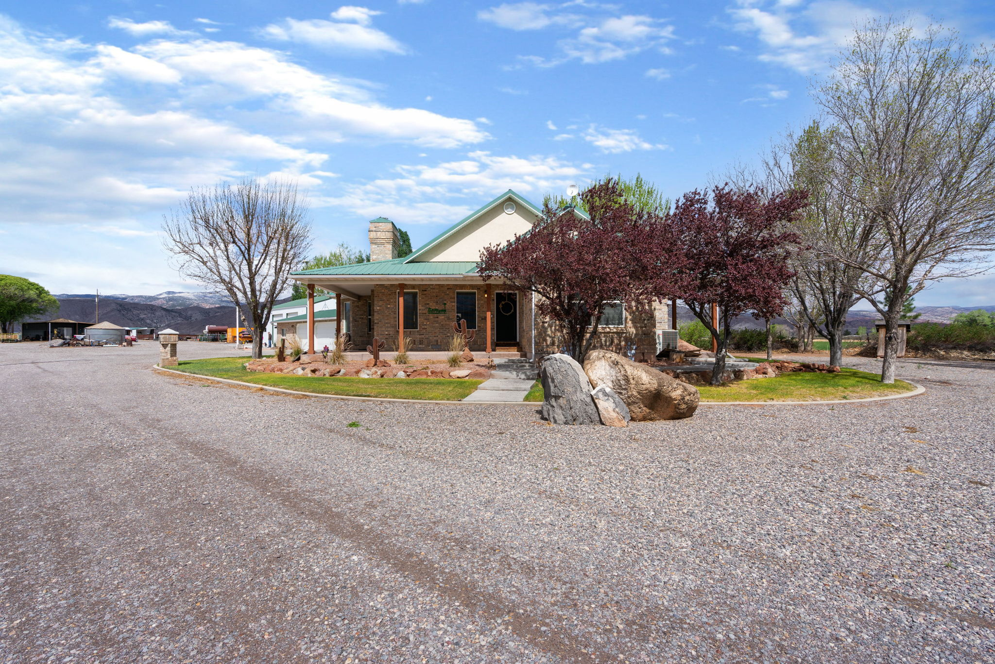 This exceptional property is set up perfectly for horses and country living. The 21+ acres include a 115' x 200' arena, horse corrals, stalls, hay barn, tack shed, 10 shares of water, and multiple outbuildings-providing everything needed for a turnkey operation.  The well-maintained all-brick home was built with quality and longevity in mind, featuring a durable metal roof and a wrap-around porch to take in the peaceful surrounding views. A spacious 42' x 56' shop offers plenty of room for equipment, hobbies, or projects.  The detached three-car garage includes a studio apartment, ideal for guests, rental potential, or a home-based business. Appliances, round pen, cattle doctoring alley, and chute are all included.  With room for livestock, equipment, and recreation, this property has everything you'll need and is ready to go!