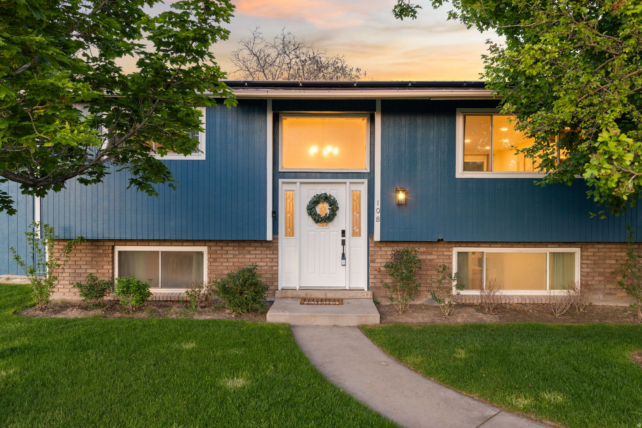 Beautifully remodeled Orem home with daylight ADU, fully paid solar, and incredible outdoor living! Ideal for owner-occupants, multigenerational living, guests, or rental income potential. Located in a quiet, established neighborhood, the main level has been extensively remodeled with a stunning designer kitchen featuring quartz countertops, full quartz backsplash, stainless steel appliances, stylish lighting, new flooring, updated windows, modern railings, and a gorgeous fireplace that creates a warm, upscale feel throughout the home. The beautifully updated bathroom includes custom tile and euro glass shower doors. Upstairs laundry included. The daylight basement apartment is clean, bright, and highly functional with its own kitchen, updated flooring, new carpet, lighting, appliances, private laundry, and separate entrance through the 2-car garage. Outside you'll find a newly landscaped yard with new sod and sprinkler system, garden beds, fire pit, fruit trees, raspberry bushes, and plenty of space to relax or entertain. Two large storage sheds and abundant storage throughout the property. Additional features include owned solar panels with extremely low power bills (approximately $10/month), newer roof, newer HVAC, central A/C, newer water heater, water softener, and new windows throughout. Excellent Orem location close to UVU, parks, shopping, restaurants, and freeway access. Furniture is negotiable.   Square footage figures are provided as a courtesy estimate only and were obtained from county records.  Buyer is advised to obtain an independent measurement.
