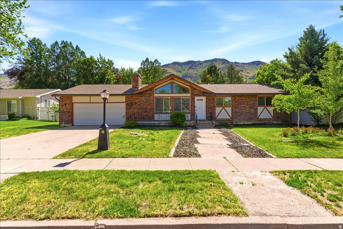 Beautifully Updated Home in Coveted North Logan Location! Over 3,000 Sq Ft Welcome to 1520 N 1600 E in North Logan-just minutes from Utah State University and nestled in one of the valley's most desirable neighborhoods. This spacious 5-bedroom, 2-bathroom home also includes a dedicated office with breathtaking mountain views.  The entire home has been thoughtfully updated, showcasing expansive windows that fill the living room and kitchen with natural light. A large kitchen island offers ample space for gathering and entertaining. The oversized two-car garage provides generous storage and utility. Don't miss this rare opportunity for space, comfort, and location in one of Cache Valley's premier areas! Square footage figures are provided as a courtesy estimate only.