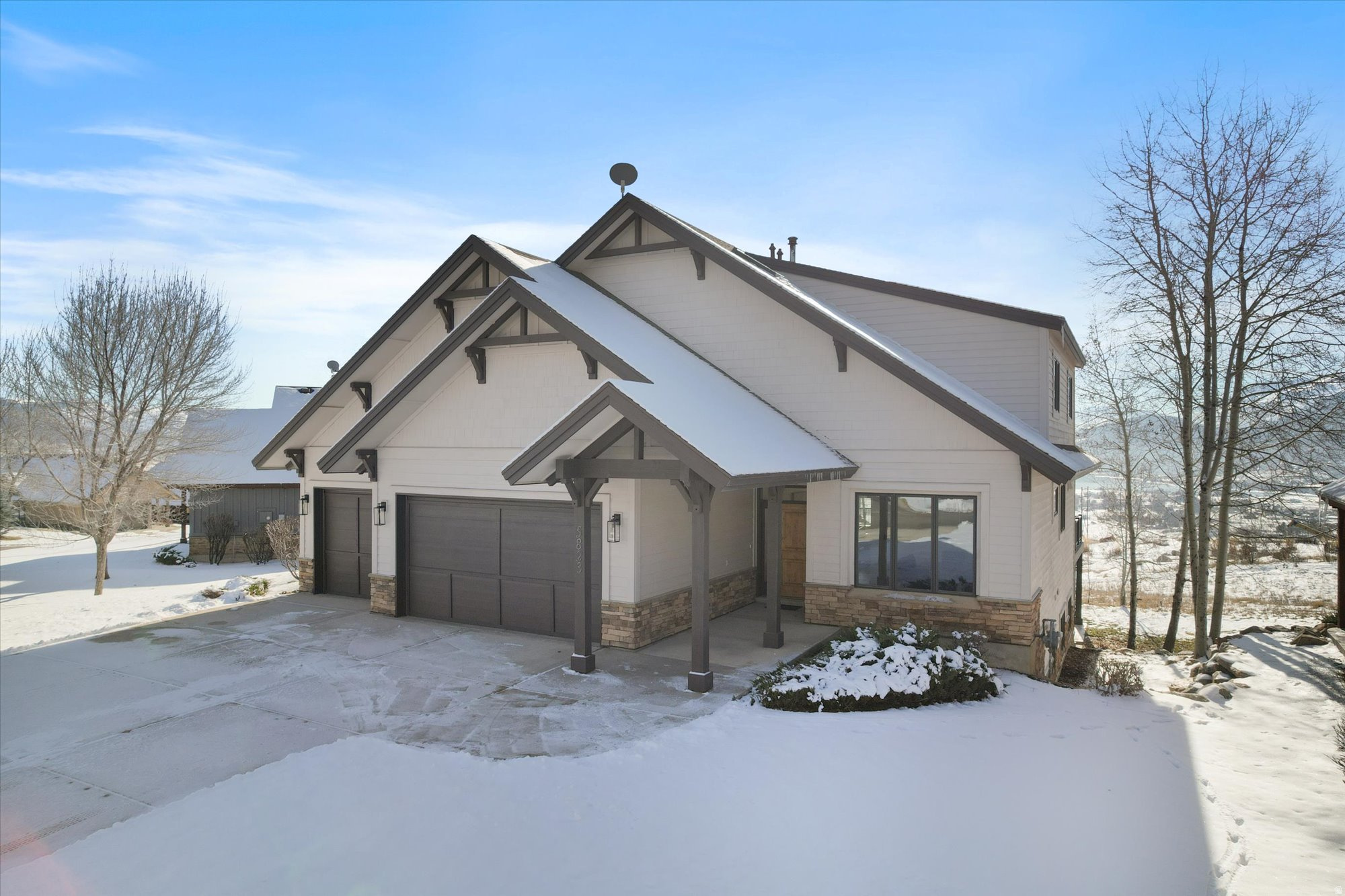Positioned in the highly sought-after Trapper's Ridge community, this mountain retreat offers a rare opportunity for a primary residence, luxury getaway, or income-producing vacation rental. Located in one of the limited areas permitting short-term rentals, the home captures sweeping, unobstructed views of Pineview Reservoir and the iconic slopes of Snowbasin Resort, delivering an elevated alpine living experience. Every inch of the interior has been thoughtfully reimagined with a focus on refined design and modern functionality. The gourmet kitchen serves as the heart of the home, seamlessly flowing into an expansive dining space ideal for hosting gatherings both large and intimate. The open-concept living area is bathed in natural light, highlighted by oversized sliding glass doors that frame the surrounding mountain and water views. A striking accordion-style pass-through window connects the kitchen directly to the deck, creating effortless indoor-outdoor entertaining. Outdoor living is equally impressive. The extended deck, complete with a new stair addition, offers generous space for relaxing, dining, and enjoying the fresh mountain air. An in-ground hot tub provides the perfect setting to unwind after a day of adventure. A dedicated locker room with a drinking fountain adds a thoughtful touch, offering convenient storage and functionality for ski gear and outdoor equipment. Ideally situated just minutes from Powder Mountain and Nordic Valley Ski Resort, and approximately 20 minutes from Snowbasin, the home is surrounded by world-class, year-round recreation. From skiing and snowboarding in the winter to boating, paddleboarding, and lakeside relaxation at Pineview Reservoir in the summer, adventure is always within reach. Offered fully furnished and turnkey, this exceptional property is ready for immediate enjoyment. Whether you envision a serene mountain escape, a high-performing short-term rental, or a full-time residence immersed in nature, this Trapper's Ridge home delivers an unparalleled lifestyle opportunity. Square footage figures are provided as a courtesy estimate only. Buyer is advised to obtain an independent measurement.