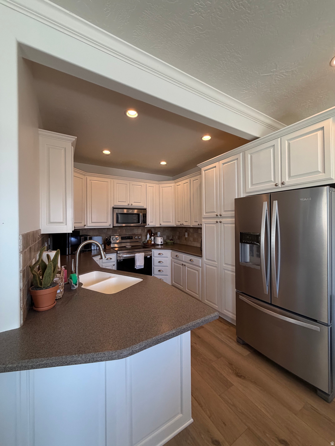 Welcome to this beautifully updated end-unit townhome in the heart of American Fork! Combining modern upgrades, extra outdoor space, and an unbeatable location, this home offers exceptional value in one of the area's most desirable communities. Step inside to find fresh paint and new flooring throughout, creating a bright, clean, and move-in-ready interior. Major mechanical updates provide added peace of mind, including an updated furnace and air conditioning system, plus a water heater and water softener that are both just one year old. The spacious, remodeled basement offers incredible flexibility and can serve as a second family room, recreation space, home office, or a fourth bedroom to fit your needs. Outside, enjoy one of the larger and deeper backyard spaces in the community-perfect for relaxing, entertaining, gardening, or giving kids and pets more room to play. Located in a well-maintained gated community, residents enjoy access to a clubhouse and community pool while being just minutes from shopping, restaurants, schools, parks, and convenient freeway access. To make your move even easier, the seller is including a one-year home warranty and will pay the HOA transfer fee. With its extensive updates, flexible floor plan, premium end-unit location, and fantastic community amenities, this American Fork townhome is one you won't want to miss! Buyer to verify all listing information.