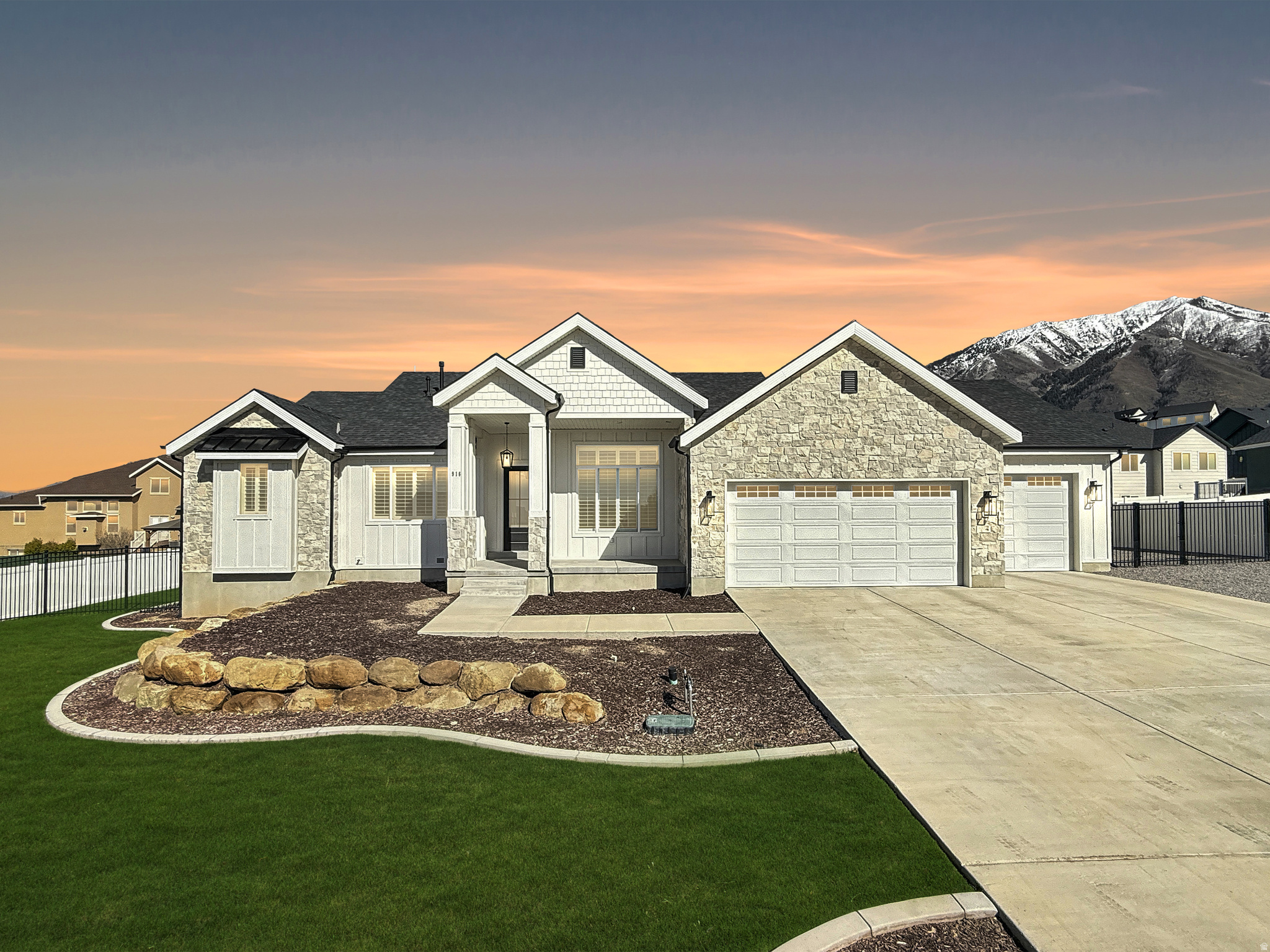 ** HUGE PRICE IMPROVEMENT! OPEN HOUSE: Saturday (6/6) from 11:00-2:00 ** This thoughtfully designed, high-end home balances clean design, functional living, and elevated finishes throughout. The main level immediately opens up into a bright, airy great room with 12-foot ceilings and a wall of windows that brings in incredible natural light. Anchoring the space is a stunning floor-to-ceiling stone fireplace with a custom mantle, creating a warm and finished focal point that ties the room together. The kitchen is both refined and highly functional, featuring inset cabinetry, 3cm quartz countertops, a gas range with a custom hood, double wall ovens, and a spacious walk-in pantry with its own window and mountain views. Just off the kitchen, a large dining pop-out provides flexibility for both everyday meals and hosting. One of the standout design elements in the home is the open staircase, paired with a subtly beautiful accent wall that adds texture and visual interest as it connects the main level to the basement below. Near the entry, a beautifully finished front office offers the perfect work-from-home setup. Plantation shutters throughout much of the home elevate both privacy and style, adding to the overall clean and cohesive feel. The primary suite is spacious and well-appointed, with large windows and a thoughtfully designed en suite featuring a dual vanity, a vessel soaking tub, and a large tiled shower with Euro glass. Throughout the home, you'll find 8-foot doors finished in a soft gray tone, complemented by black hardware that pops against the crisp white walls. The basement has been partially finished to expand your living space, offering one large open family room that has been thoughtfully set up for a future theater area-with a ceiling outlet and conduit already in place for a projector-positioned right next to a full wet bar complete with a sink, microwave, mini fridge, and custom cabinetry. You'll also find a cozy under-the-stairs reading nook, along with space already set up for two additional bedrooms and a future bathroom. Stepping outside, the home sits on over a third of an acre with full landscaping and fencing already in place. The covered back patio is ideal for relaxing or entertaining and includes a gas stub for a future grill. Along the side of the home, you'll find expansive RV parking-22 feet wide and 76 feet long-with a large gate for flexible access and secure storage. The oversized three-car garage offers extra height, width, and depth, along with an enclosed workshop space-perfect for projects, storage, or hobbies. Additional features include stainless steel appliances throughout, a recirculating hot water system for near-instant hot water, and a gas line already in place for a future dryer. Located in a desirable Elk Ridge neighborhood with excellent schools, nearby parks, and easy access to everyday conveniences, this home offers you both lifestyle and location together in one complete package. Schedule your showing today! Square footage figures are provided as a courtesy estimate only and were obtained from the building plans. Buyer is advised to obtain an independent measurement.