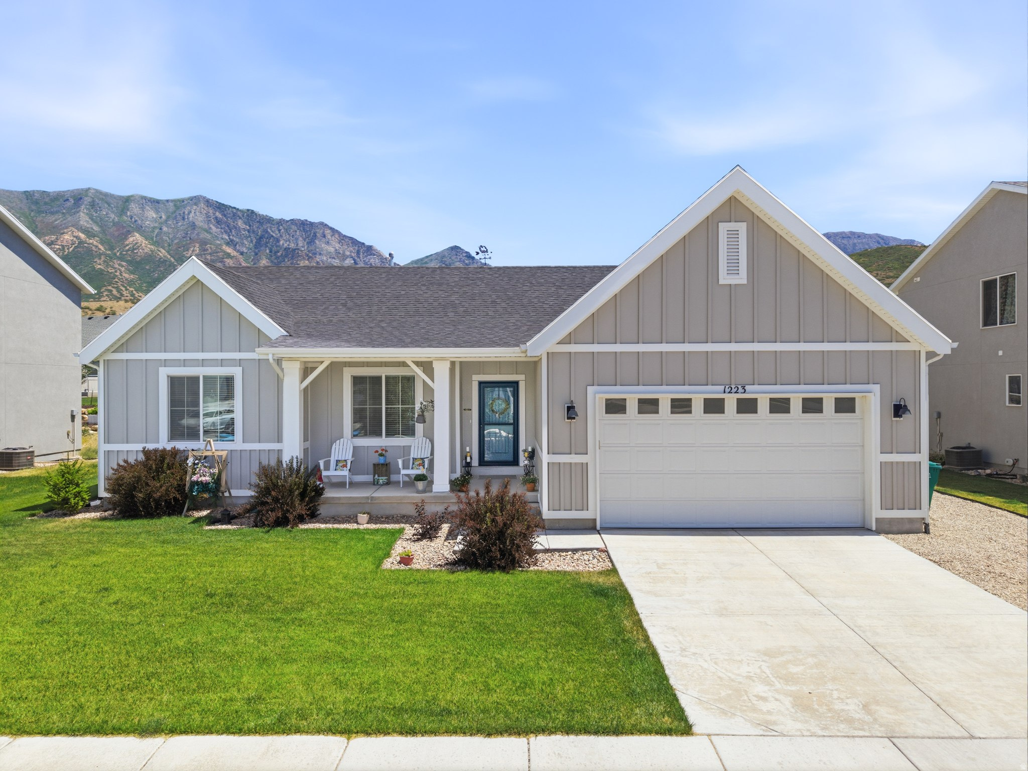 Welcome to Red Cliff Drive, where mountain views greet you before your coffee even finishes brewing. Tucked into Santaquin's sought after Foothill Village neighborhood, this home pairs everyday comfort with the kind of scenery that makes you linger on the porch a little longer each morning. Step inside to a light filled open concept living space with wide plank flooring flowing through the main level. The kitchen is a true gathering spot, featuring crisp white cabinetry, dark quartz countertops, stainless steel appliances including a gas range, and an oversized island with bar seating for four. The adjoining dining area opens through sliding glass doors to a backyard framed by dramatic foothill views, perfect for evening dinners with a view that never gets old. The primary suite offers a peaceful retreat with a tray ceiling, plush carpet, and generous space for a full furniture suite. Upstairs bathrooms bring updated vanities, quartz counters, and tasteful tile work, while a dedicated laundry room and abundant closet storage keep daily life organized.  Out front, a covered porch invites you to sit back and enjoy the neighborhood, while the location itself does plenty of the selling. Santaquin blends small town charm with real convenience, offering quick access to I-15, local shopping, restaurants, and the outdoor playgrounds of Santaquin Canyon and nearby Payson Canyon. Outdoor lovers will love how close the mountains truly feel. Homes with this combination of updated finishes, real storage potential, and unbeatable views do not sit long in this market. Reach out today to schedule your private showing. Please note possession must be AFTER August 18, 2026.
