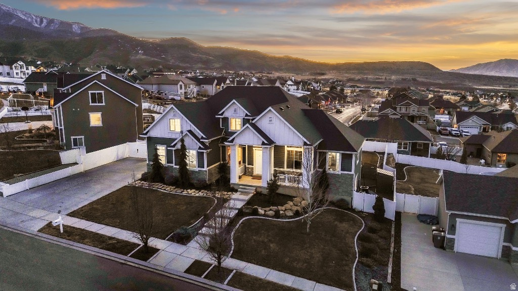 Seller is willing to do up to $20,000 in closing costs for strong offers.  Mountain and Lake Views! Hot tub included! Live in luxury while the walk-out 3BR/2BA basement pays your mortgage ($2k/mo proven rental). Features a stunning wall of windows, custom LEDs, and all-new updated modern lighting throughout. 2 EV chargers in the garage! The yard is a private oasis: fruit trees, berries, landscaping, and a screened gazebo with a hot tub hook-up. High-tech, high-income, and modern finishes. Perfect!