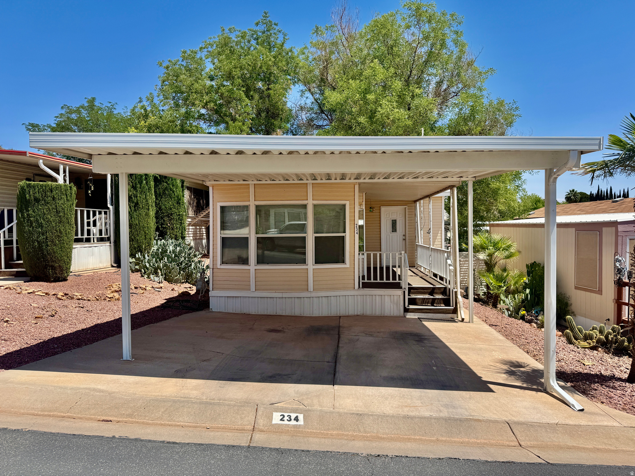 55+ Community in a smaller RV park! This 2 bedroom, 2 bath home features nice flooring, a spacious porch, and comfortable living space. Enjoy community amenities including a pool, clubhouse, and gym, all with a low HOA. Buyer to verify all information.