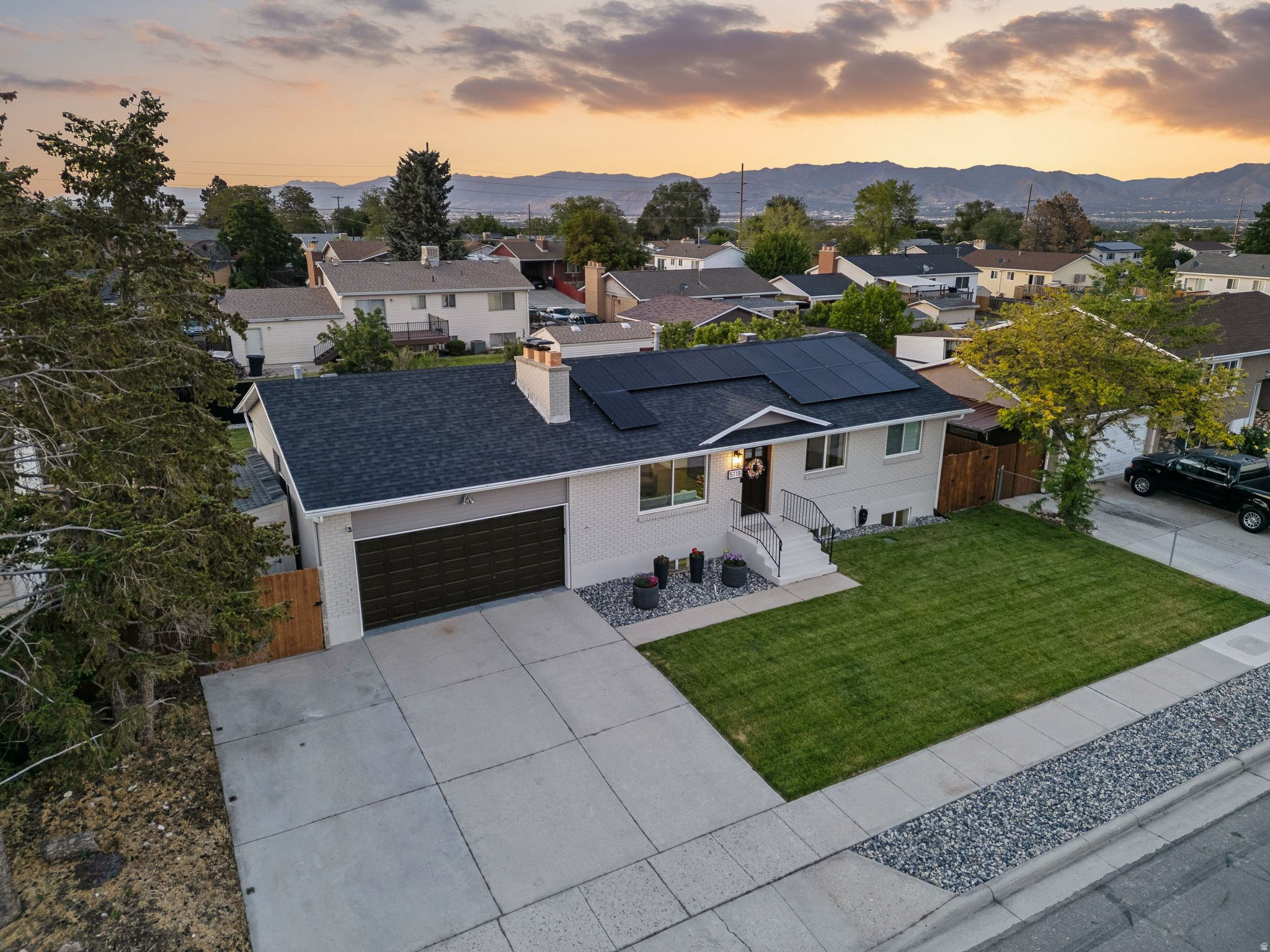 Located just north of the Olympic Oval and home to the 2034 Winter Olympics, this beautifully renovated Kearns residence has been thoughtfully updated from top to bottom. Combining modern finishes, major system upgrades, and exceptional outdoor space, this move-in-ready home offers both comfort and convenience. The stunning kitchen serves as the heart of the home, showcasing sleek quartz countertops, custom cabinetry, stainless steel appliances, and a sliding glass door that opens directly to the backyard. Updated bathrooms feature fresh, contemporary finishes that create a clean and inviting atmosphere throughout. Recent improvements provide peace of mind, including a brand-new roof, energy-efficient windows, and solar panels designed to help reduce utility costs. Large basement windows bring in abundant natural light, creating bright and welcoming living spaces on both levels. Outside, you'll find a newly reimagined front and backyard with new fencing, fresh landscaping, a spacious backyard perfect for entertaining, and a covered patio ideal for relaxing year-round. The property also includes a generous 6' x 16' storage shed, offering plenty of room for tools, outdoor gear, and seasonal items. With extensive updates, stylish finishes, solar power, and a fantastic location close to parks, recreation, and commuter routes, this Kearns home is a rare opportunity you won't want to miss.