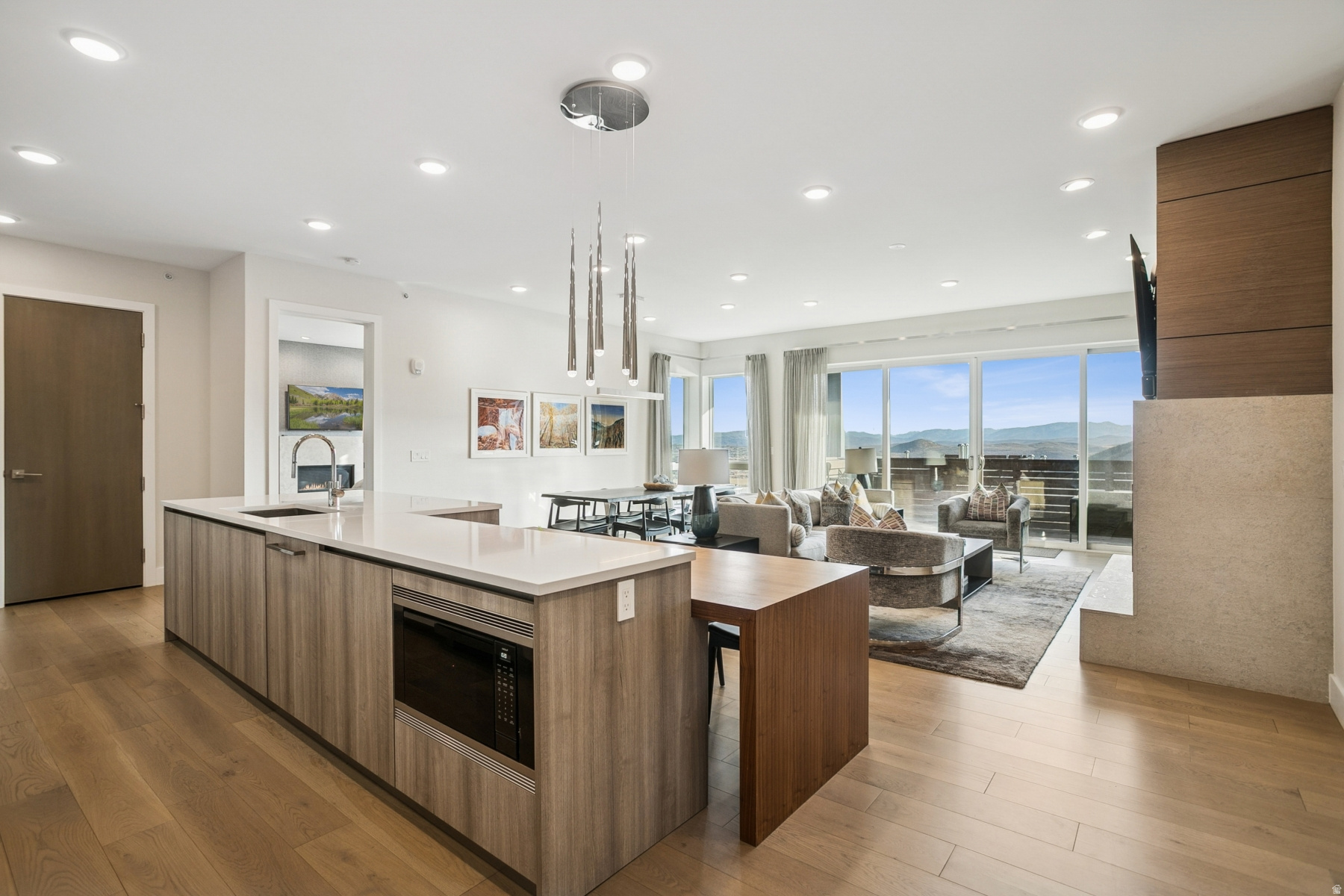 Enjoy this premiere location in Canyons Village with true ski-in, ski-out access to not one but three lifts, right from your door. This 4-bedroom, two level residence at Apex Residences redefines modern mountain living with sleek design, generous spaces, and effortless luxury. The floor-to-ceiling windows offer sweeping mountain views of the Wasatch and Uintah Mountain Ranges, as well as slope side resort surroundings. The open main living area is perfect for entertaining or unwinding after a day on the slopes, with a large deck to enjoy the outdoor atmosphere. Also located on the main level is the primary suite with fireplace and a luxurious primary bath. The lower level has a separate family room, that provides a cozy retreat for family gatherings, along with three additional bedrooms, and a second deck with a private hot tub. Every surface has been thoughtfully curated with custom wall coverings, custom drapery, motorized blinds, and high-end finishes throughout.  Owners enjoy exclusive access to world-class amenities, including a 5,000-square-foot clubhouse featuring a heated pool, hot tub, fitness center, owner's lounge, treatment rooms, and an event kitchen.   Furnishings can be purchased separately. Begin enjoying your mountain retreat right away!