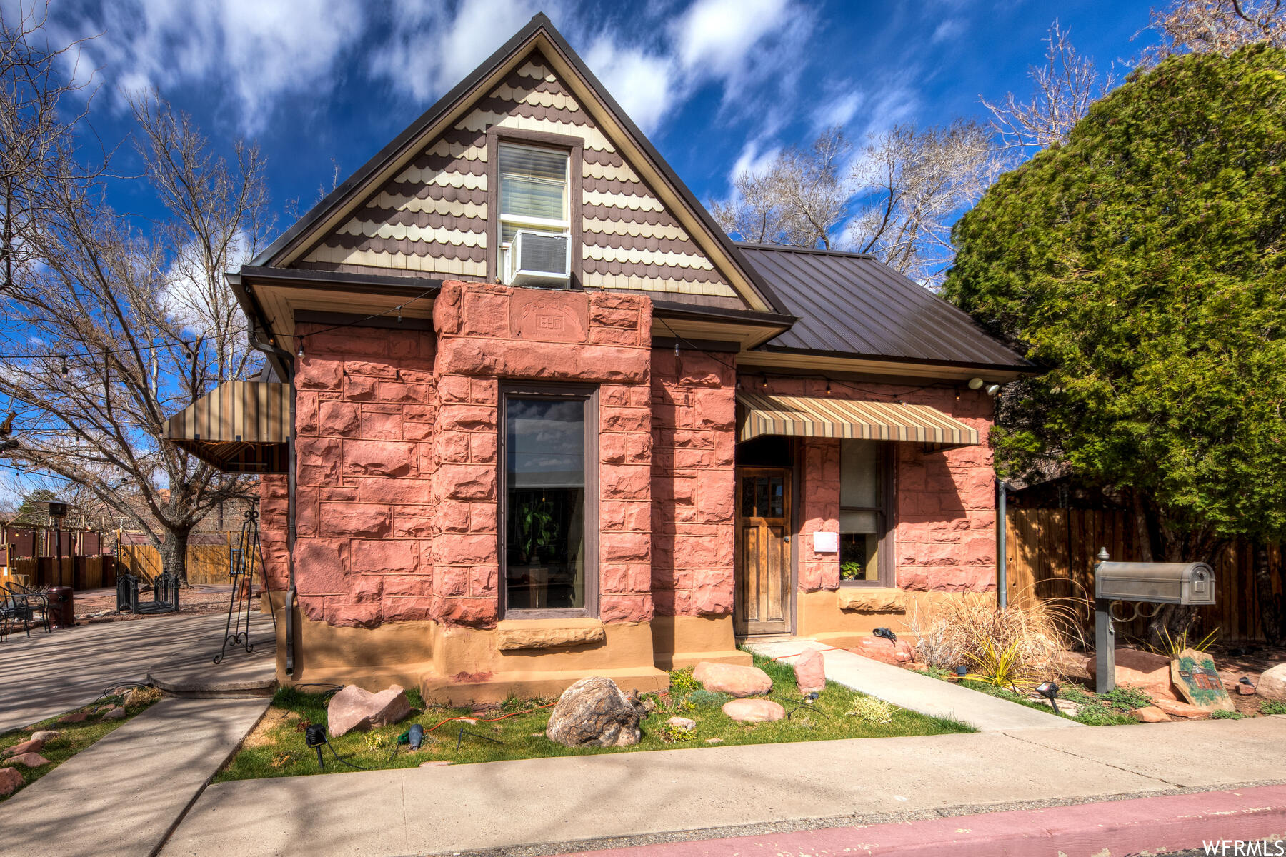 Charming Historic Commercial Building in Downtown Moab! This building features 1900+ square feet and is currently ran as a restaurant. Zoned Moab City C-3, this offers a variety of commercial opportunities. The historic structure is stunning with handmade sandstone bricks, the roof is a new metal roof, and mature beautiful trees wrap the Street Side and create a charming outdoor dining space. Lease in place with the restaurant business.