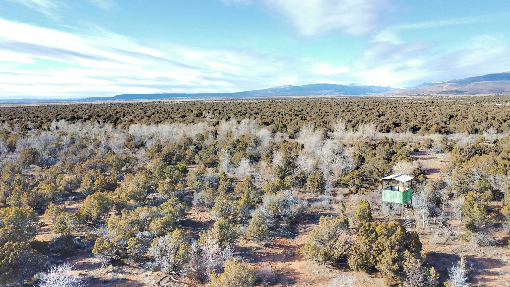 The Uintah Foothills Ranch is a unique 480-acre property located just outside of Neola, Utah, offering expansive space, privacy, and sweeping views across predominantly flat to gently rolling terrain. The natural landscape of the property provides excellent usability throughout, with broad juniper flats framed by bordering pine-lined riparian corridors of the East Channel of the Uinta River and the distant Uinta Mountains!  The terrain of Uintah Foothills Ranch is ideal for those seeking a versatile property. The gently rolling hills are covered primarily in juniper trees interspersed with sagebrush, offering a blend of open spaces and natural cover. Two canals traverse the property, the Uintah Independent Canal, for which the current owners hold water shares, and the Bypass Canal, which runs through a smaller section of the land. Power runs directly through the property, creating an excellent opportunity for future development, whether for a recreational retreat or a permanent residence! A portion of the eastern boundary adjoins tribal lands, adding a distinctive edge to the property's layout and enhancing its privacy. Wildlife is present throughout the ranch, with deer frequently seen, providing modest hunting opportunities and further enriching the experience of this western landscape.  Beyond the property boundaries, the area is rich in recreational options. The Ashley National Forest and the Uinta River lie less than 20 minutes north, offering exceptional trout fishing along with access to hiking, backpacking, hunting, camping, and alpine lakes and streams within the High Uintah Wilderness.  Several lakes  are within an hour away providing additional fishing, boating, and camping opportunities. Dinosaur National Monument, known for its dramatic historic landscape, is within an hour, while Flaming Gorge Reservoir and the Green River, roughly 1 hour and 30 minutes away, offer world-class boating and fishing experiences. This remarkable location makes the Uintah Foothills Ranch a true gateway to the natural wonders of northeastern Utah.  The Uintah Foothills Ranch is located just outside the community of Neola, offering a private rural setting while remaining within convenient reach of essential services. The town of Roosevelt, approximately 20 minutes away, provides restaurants, grocery stores, hardware stores, and medical services. Vernal, located just over a half hour from the property, offers expanded shopping, dining, medical facilities, and a regional airport, making travel and extended stays convenient. Private access roads lead directly to the property, ensuring seclusion while maintaining reasonable proximity to necessary conveniences and recreational destinations.