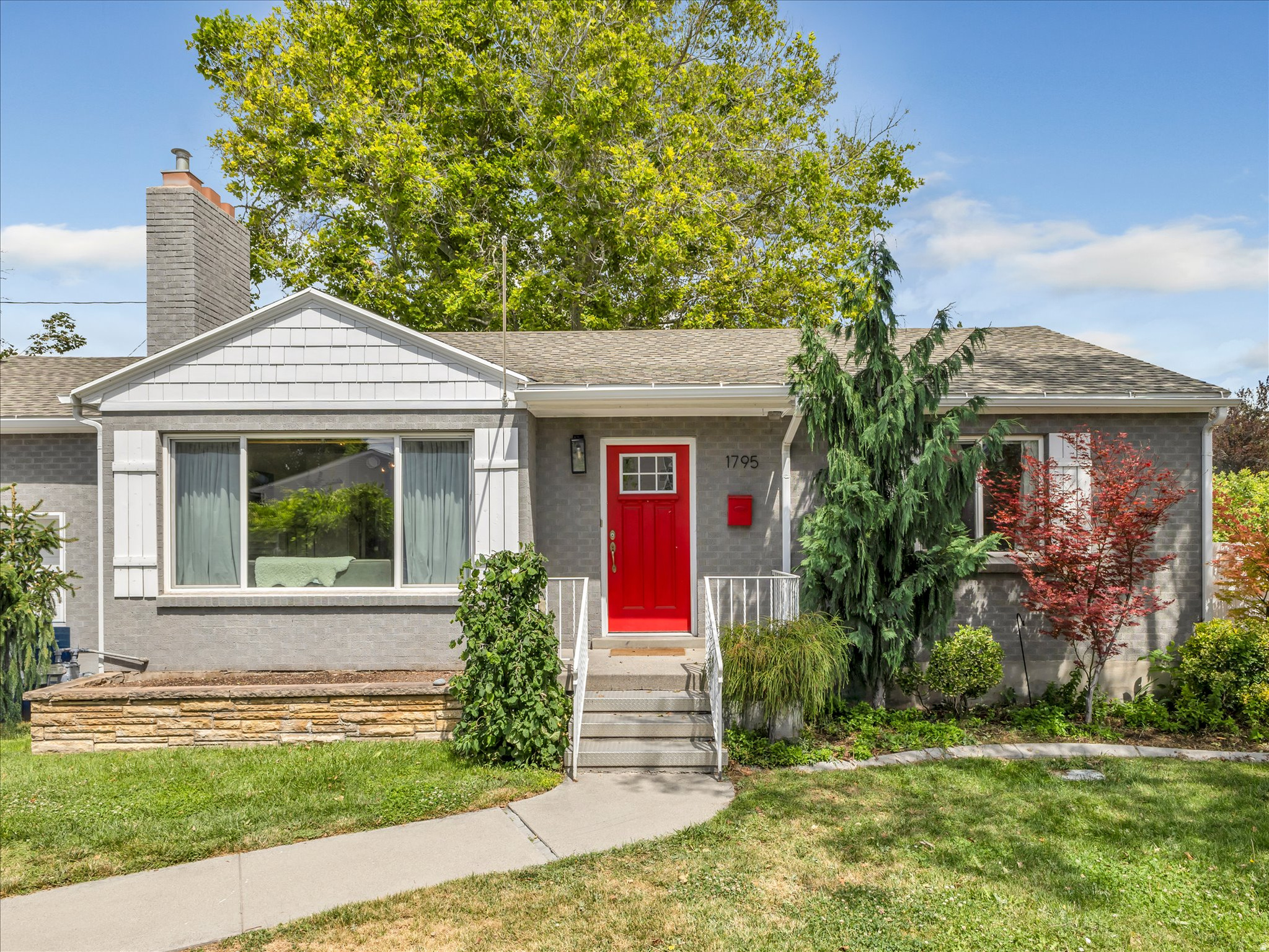 Beautifully remodeled rambler in one of Holladay's desirable neighborhoods! The open-concept great room features vaulted ceilings and a cozy fireplace, creating a warm and inviting gathering space. The updated kitchen offers a large center island, gas range, abundant counter space, and is perfect for entertaining. The main level includes two bedrooms and two bathrooms, including a private primary suite. The fully finished basement provides excellent flexibility with a kitchenette, spacious family room, three additional bedrooms, and a laundry room-ideal for guests, multi-generational living, or a mother-in-law setup. Enjoy the spacious backyard with raised garden beds, mature shade trees, and a covered patio, or relax on the charming front patio beneath the pergola and porch swing. The backyard chickens, along with their coop and fenced enclosure, are negotiable. Surrounded by beautiful mature trees, mountain views, and a walkable neighborhood, this home offers an exceptional setting. Easy access to downtown Salt Lake City, Park City, and Big and Little Cottonwood Canyons, offering world-class skiing, hiking, and outdoor year-around recreation.