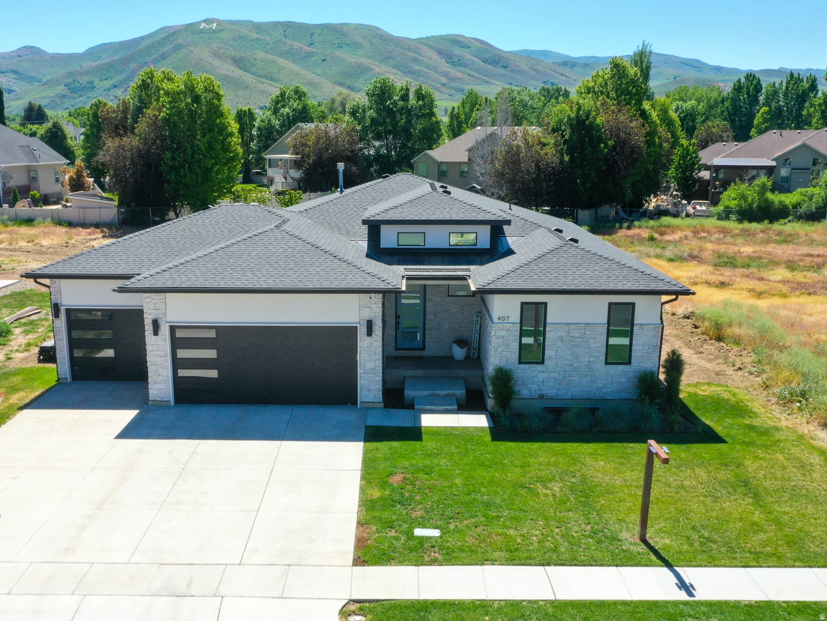 Priced to sell! Welcome to this stunning 4,080 sq. ft. modern Rambler situated on a spacious .37 acre lot in the heart of Morgan, Utah. This thoughtfully designed 3 bedroom, 2 1/2 bathroom home offers luxurious single level living with incredible mountain views in every direction. Step inside to a light-filled open floor plan featuring a spacious great room with soaring ceilings, a cozy fireplace, and expansive windows that flood the home with natural light. A beautiful kitchen is a chef's dream, boasting stainless steel appliances-including a oven/microwave combo, quartz countertops, and a large island perfect for entertaining. The expansive primary suite offers a private retreat with double sinks, an oversized walk-in shower, and a large walk-in closet. Two additional bedrooms provide ample space for family or guests, each with access to well-appointed bathroom. Enjoy the flexibility of a full unfinished basement-ready for you to customize to fit your lifestyle plumbed for two additional bathrooms, room for 3 bedrooms, and a potential 2nd kitchen. Step out onto the modern deck and take in breathtaking views of your backyard and the surrounding Wasatch mountains. Additional highlights include an oversized 4-car garage with a tandem bay (fits 2 vehicles), and a prime location close to schools, shopping, and endless recreational opportunities. This is mountain living at its finest-modern luxury, space to grow, and incredible views.