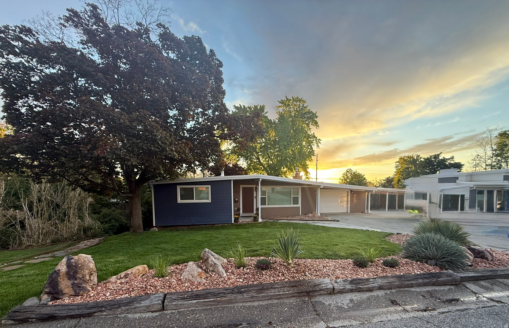 Fully renovated retreat with stunning Mount Olympus views, tucked away on a quiet horseshoe street in one of Holladay's most sought-after neighborhoods. This is not your typical packed-in suburban property. With minimal traffic, mature trees, creek-side privacy, and rare separation from neighbors, the home offers a peaceful, secluded feel that's hard to find this close to the city. Inside, the home delivers the warmth and functionality of a high-end gourmet kitchen and luxury living space - without the overwhelming upkeep. This 4-bedroom, 3-bath home features an open-concept layout, real hardwood floors, new windows and doors, smart switches throughout the main level, smart thermostat and sprinkler system controls, and beautifully updated bathrooms including two walk-in showers. The primary suite includes a private ensuite bathroom, creating a comfortable and functional retreat within the home. The thoughtfully redesigned kitchen features custom drawer storage, a convection cooktop, and a premium built-in oven with multifunction convection microwave/oven combination, delivering the look and functionality of a double oven while maximizing space and versatility. The kitchen flows seamlessly into the main living space centered around a brand-new remote-controlled gas fireplace. Major system upgrades include a brand-new fully grounded main electrical panel and meter brought up to current code, giving peace of mind alongside the home's extensive cosmetic renovations. Downstairs offers additional living space, stamped concrete flooring, a separate mother-in-law entrance, a full bathroom with tub, and a beautifully finished second kitchen featuring custom cedar cabinetry and dishwasher - ideal for guests, a private guest suite, multigenerational living, or flexible use of the space. Outside, enjoy walk-out patios and deck space, a hot tub with incredible Mount Olympus views, natural gas hookups, mature landscaping, a large fenced backyard with brand-new fencing, and a unique creek-side buffer creating extra privacy and greenery between neighbors. Additional features include:  Whole-house water filtration system  Reverse osmosis systems upstairs and downstairs  Heated garage with bonus storage/workspace  Google Fiber  Large shed on concrete pad  RV/extra parking  Smart thermostat and smart sprinkler system  Brand-new remote-controlled gas fireplace  New fencing and landscaping  Two refrigerators included  Washer and dryer included  Low-traffic horseshoe street  Minutes from top-rated schools, shopping, restaurants, and outdoor recreation. Showings available by appointment with advance notice. Please be respectful of occupants and do not disturb. This is a rare opportunity to own a move-in-ready Holladay property that combines privacy, location, thoughtful upgrades, and a true retreat-like setting. (Square footage amount includes modifications)