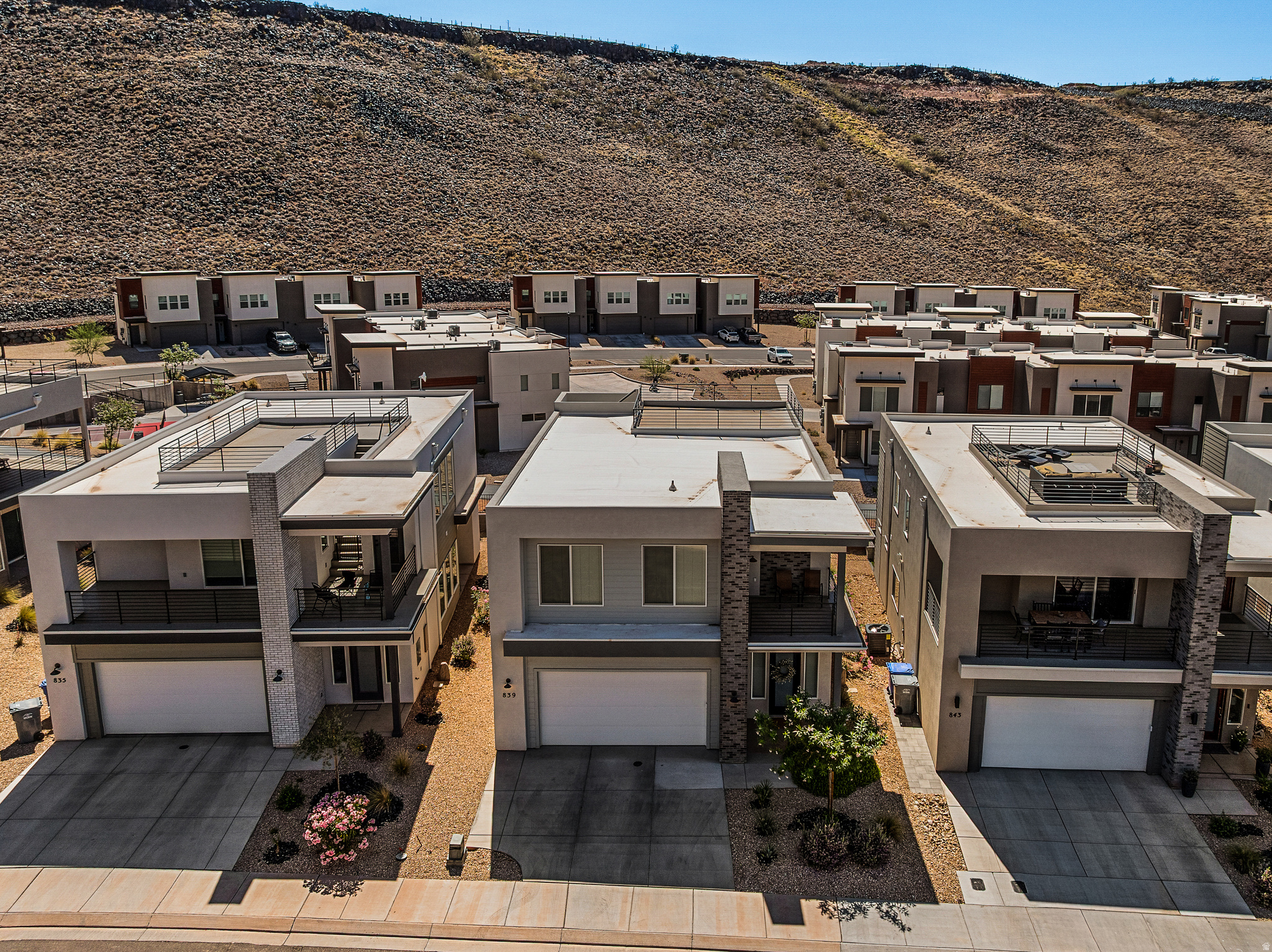 Wake up to desert sunrises, spend your mornings on miles of paved walking and biking trails, challenge yourself on the nearby Dragontail Stairs, then unwind beneath a sky full of stars from your private rooftop deck. This is Southern Utah living at its best. Thoughtfully designed for both adventure and relaxation, the home offers bright, modern spaces and seamless indoor-outdoor living. The rooftop deck creates a rare extension of the home--perfect for entertaining, sunset gatherings, morning coffee, or simply soaking in the views. HOA amenities provide a resort-style lifestyle with a pool, hot tub, fitness center, pickleball courts, parks, playgrounds, and full yard maintenance, giving you more time to enjoy the things that matter most and less time worrying about upkeep. 3 bedrooms and a den make this home very livable.