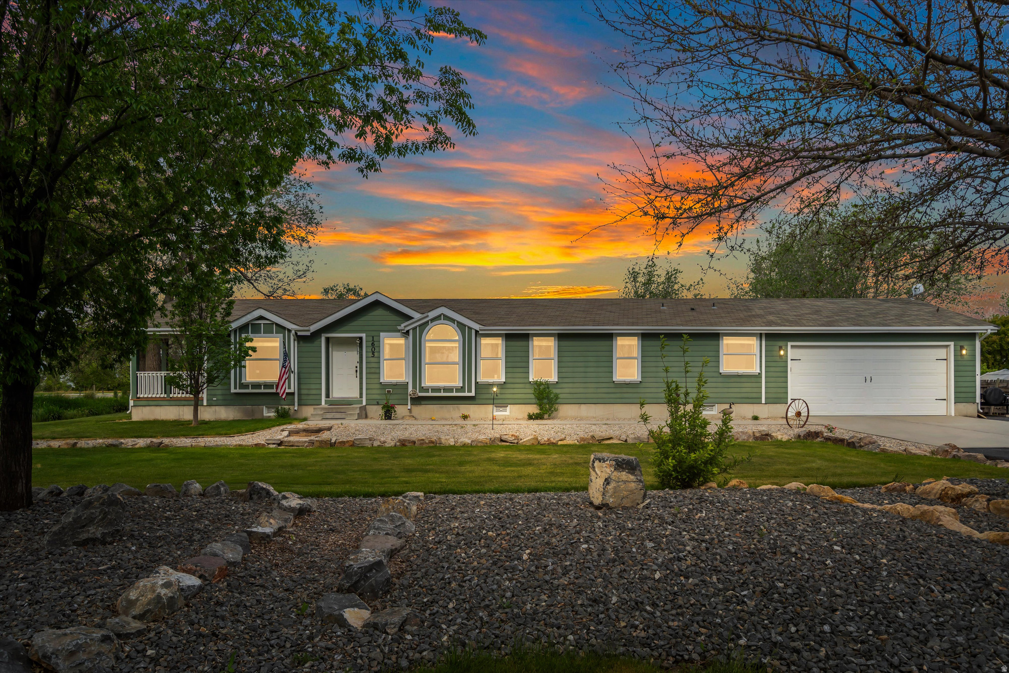 Experience peaceful country living with this beautifully updated home situated on nearly half an acre in Corinne. Surrounded by breathtaking mountain views, this property offers the perfect balance of comfort, functionality, and outdoor space. Inside, you'll find fresh updates throughout including new flooring, paint, and large bathrooms, along with a spacious kitchen ideal for everyday living and entertaining. Vaulted ceilings and abundant natural light create an open, welcoming feel.  The oversized attached 2-car garage provides excellent space for vehicles, storage, or a workshop setup, while the expansive paved parking area offers plenty of room for RVs, trailers, toys, and guests. Outside, mature trees, fruit trees, a vegetable garden area, and full landscaping create a private country retreat with room to enjoy. Conveniently located on a corner lot with stunning views in every direction, this property combines rural charm with practical amenities and easy maintenance. Buyer to verify all information.