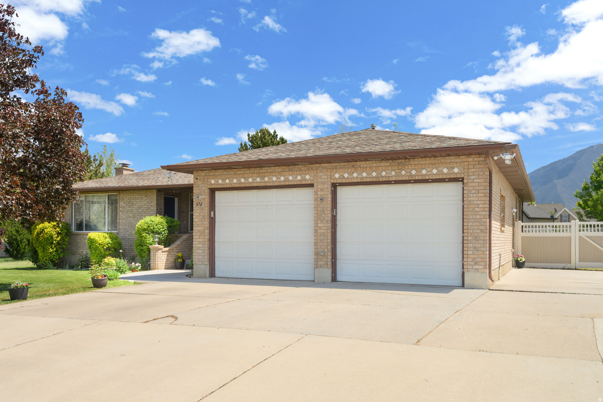 Don't miss this one! Tucked on a quiet street, this home offers a larger lot with room to spread out and enjoy. Need a home office or private workspace? A separate front porch entrance makes it easy. You'll love the oversized 2-car garage, extended driveway with plenty of parking, and a spacious storage shed for all your tools and toys. The yard is fully fenced with newer vinyl fencing and features mature shade and fruit trees. Major systems have been updated with a newer furnace and central air. Watering is simple and cost-effective with both well and culinary water. The basement includes its own entrance and second kitchen, offering great flexibility.  Basement is currently being rented (month to month).  Attached 2 car garage is extra wide and deep with higher garage doors. Square footage figures are provided as a courtesy estimate only and were obtained from _______appraisal_______ .  Buyer is advised to obtain an independent measurement.