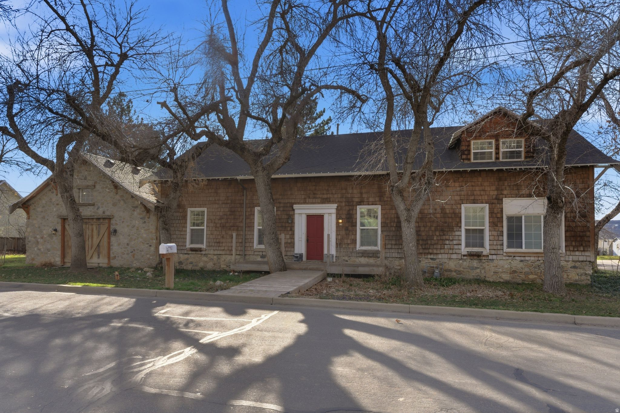 Historic Stagecoach House in Centerville  Main-floor primary suite  Oversized 2-car garage. Own a rare piece of Centerville history at this distinctive property blending preserved historic features with thoughtful additions. Original architectural elements include tall ceilings, hardwood floors, exposed beams, and the original hitching post displayed in the kitchen, reflecting the home's early role along the historic route through town. The spacious kitchen features extensive cabinetry, large center island with seating, and wood plank ceiling detail, opening to dining and gathering areas suited for entertaining. A later addition created a generous main-level primary suite with vaulted wood ceiling, large windows, private bath, sitting area, and oversized closet with attic storage. Two separate family rooms provide flexible living spaces, including a large gathering room with fireplace and vaulted ceiling. Formal dining room includes built-in shelving and display cabinetry. Outside, the property includes mature shade trees and a spacious backyard area with room for outdoor living or gardening. Oversized 2-car garage provides additional storage and parking. Located near Parrish Creek Trail, community parks, local dining, and convenient access to I-15. Fiber optics available w/ speeds up to 2.5 Gbps