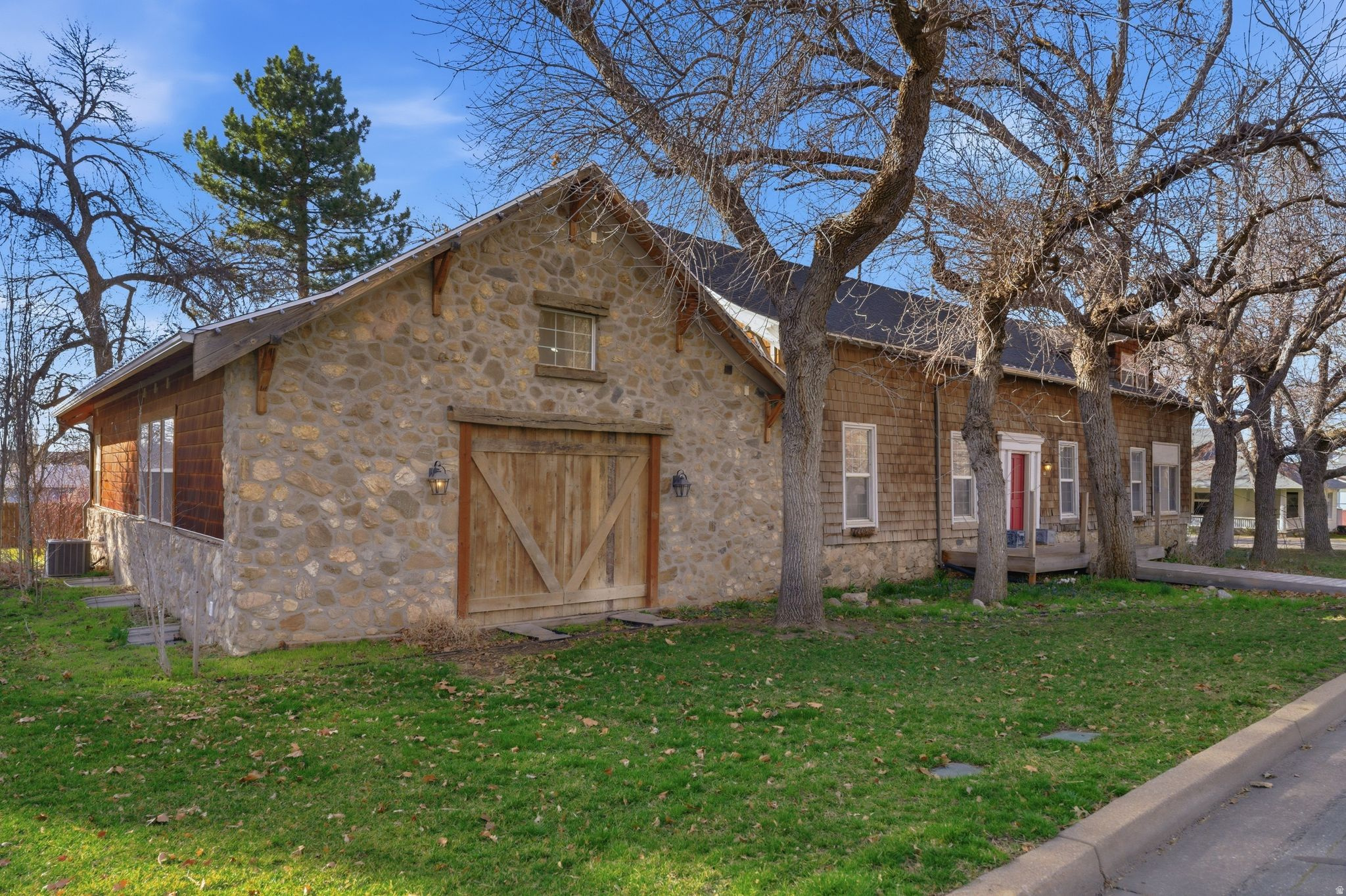 Historic Stagecoach House in Centerville  Main-floor primary suite  Oversized 2-car garage. Own a rare piece of Centerville history at this distinctive property blending preserved historic features with thoughtful additions. Original architectural elements include tall ceilings, hardwood floors, exposed beams, and the original hitching post displayed in the kitchen, reflecting the home's early role along the historic route through town. The spacious kitchen features extensive cabinetry, large center island with seating, and wood plank ceiling detail, opening to dining and gathering areas suited for entertaining. A later addition created a generous main-level primary suite with vaulted wood ceiling, large windows, private bath, sitting area, and oversized closet with attic storage. Two separate family rooms provide flexible living spaces, including a large gathering room with fireplace and vaulted ceiling. Formal dining room includes built-in shelving and display cabinetry. Outside, the property includes mature shade trees and a spacious backyard area with room for outdoor living or gardening. Oversized 2-car garage provides additional storage and parking. Located near Parrish Creek Trail, community parks, local dining, and convenient access to I-15. Fiber optics available w/ speeds up to 2.5 Gbps
