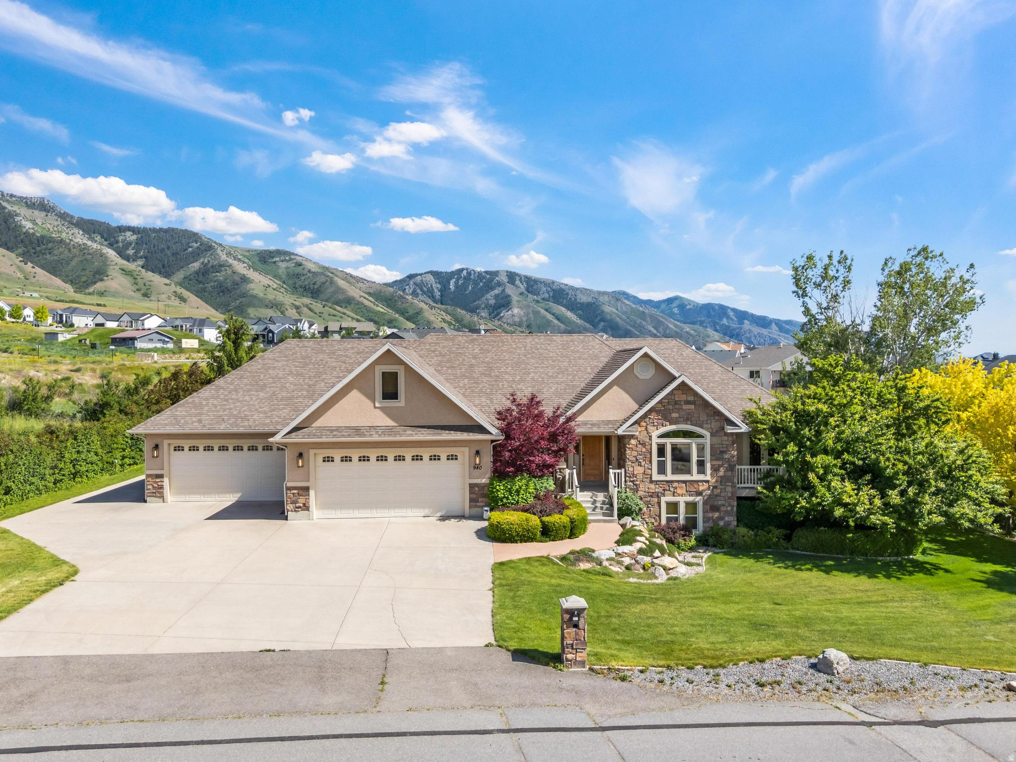 GET A LOWER INTEREST RATE - SELLER IS OFFERING a 2:1 BUYDOWN or $19,000 toward CLOSING COSTS when you use our preferred lender ...***...   LUXURY MOUNTAIN LIVING with SOLAR PANELS, an INDOOR SPORTS COURT, and NO BACKYARD NEIGHBORS!!  Enjoy stunning MOUNTAIN & VALLEY VIEWS from both inside and outside your home.  Sitting on nearly 1.3 ACRES with almost 5,000 sq. ft. of living space, a 6-CAR GARAGE, RV PARKING, and an RV ELECTRICAL HOOKUP, there is plenty of space for all your needs.  So many SPECIAL FEATURES: Indoor Sports Court; Secret Room; Duel Fuel Generator; RV pad with propane and adequate power; Wooden blinds throughout; Gas port for a grill on the covered deck.  The basement has its own SEPARATE ENTRANCE as well as a WET BAR.  LOCATION is unbeatable: Enjoy living at the base of the mountains with nearby access to hiking, biking, and breathtaking outdoor recreation.  You get the benefits of mountain living without being remote. Utah State University, shopping, restaurants, and medical services in Logan and North Logan are only a short drive away.  This is the home you've been looking for. Come see it today!  Photos are virtually staged. Information and measurements are provided as a courtesy. Buyers are advised to obtain their own measurements and verify all information.