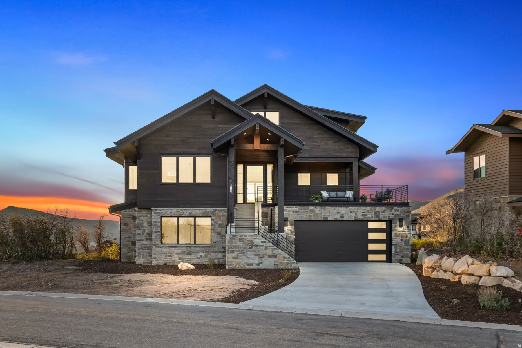 Perched above the fairways of the Outlaw Golf course in sought-after Hideout Canyon, this brand-new mountain modern residence delivers the rare combination of sweeping views, privacy, and immediate access to four-season adventure. From Jordanelle Reservoir sunsets to Deer Valley ski run vistas, every angle of this thoughtfully designed home captures the beauty of Utah's alpine landscape. Completed in 2026, this 3,912 sq ft home offers 4 bedrooms, 3.5 bathrooms, and a bright open-concept floor plan crafted for both everyday living and entertaining. The main living space features vaulted ceilings, designer finishes, and a spacious chef's kitchen that flows seamlessly into the great room and expansive view decks-- creating effortless indoor/outdoor living. The desirable main-level primary suite offers convenience and the home's best unobstructed views, featuring an oversized soaking tub perfectly positioned to take in the scenery. Above the kitchen, a versatile loft space adds flexibility for modern living--ideal as a kids' play area, home office, reading lounge, or game room. The lower level is equally inviting with a stylish wet bar, creating the perfect setting for entertaining after a day on the slopes or lake. A generous two-car garage with additional storage provides room for all your mountain gear, bikes, skis, and toys. Located just minutes from Jordanelle Reservoir, 15 minutes to Deer Valley Resort East Village skiing, and to historic Park City, this is the perfect basecamp for luxury mountain living. Community trails and golf right outside your door complete the lifestyle. A turnkey opportunity to own a newly completed view home in one of Hideout's most desirable settings.
