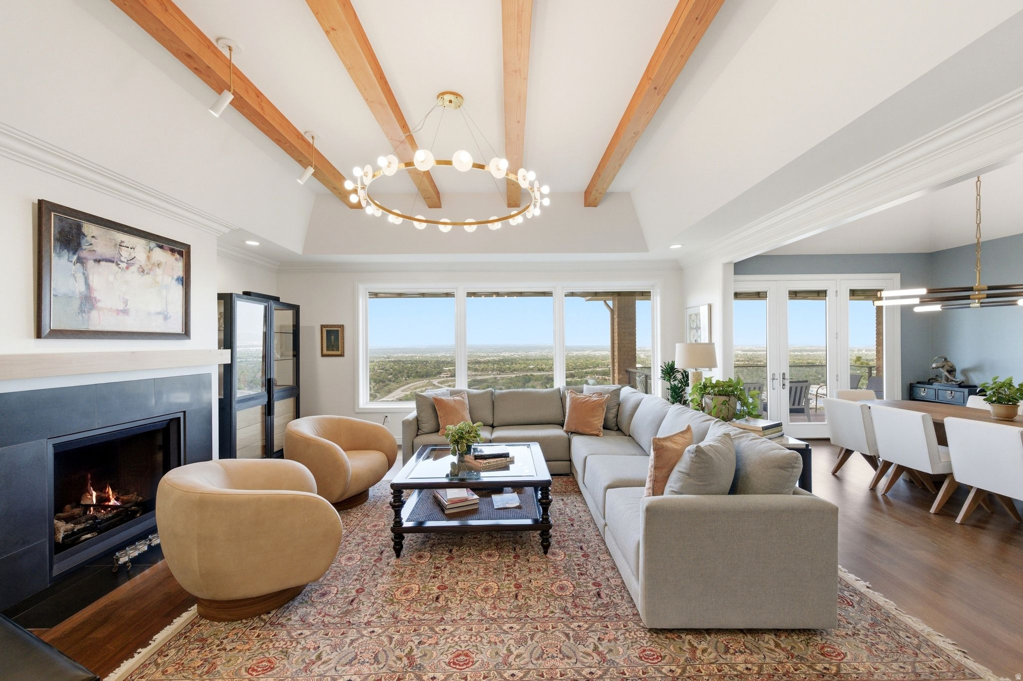 Perched high on Salt Lake's desirable east bench, this beautifully designed home offers a rare combination of luxury and sweeping views. Nearly every room captures absolutely stunning vistas of the Oquirrh Mountains, the Great Salt Lake, and downtown Salt Lake City. Inside, natural light pours through expansive picture windows, creating a seamless indoor-outdoor feel. The chef's kitchen features granite countertops, sleek European-style appliances, dual sinks, and ample storage, flowing effortlessly into the dining area, office, powder bath, and an inviting great room. Step out onto the spacious deck-perfect for entertaining or relaxing at sunset. The main-level primary suite is a private retreat with a steam shower, dual vanities, walk-in closet, and breathtaking views. Pella Designer Series windows with built in shades provide enhanced comfort and privacy. The lower level offers four large bedrooms, two updated bathrooms, flexible living space, and the convenience of a second laundry area. Outside, tiered landscaping creates usable yard space for entertaining, play, or future amenities-all set against a dramatic mountain backdrop. Located minutes from downtown Salt Lake City, the University of Utah, and world-class skiing  with Park City just a short drive away-this home delivers the perfect blend of convenience and elevated mountain living.
