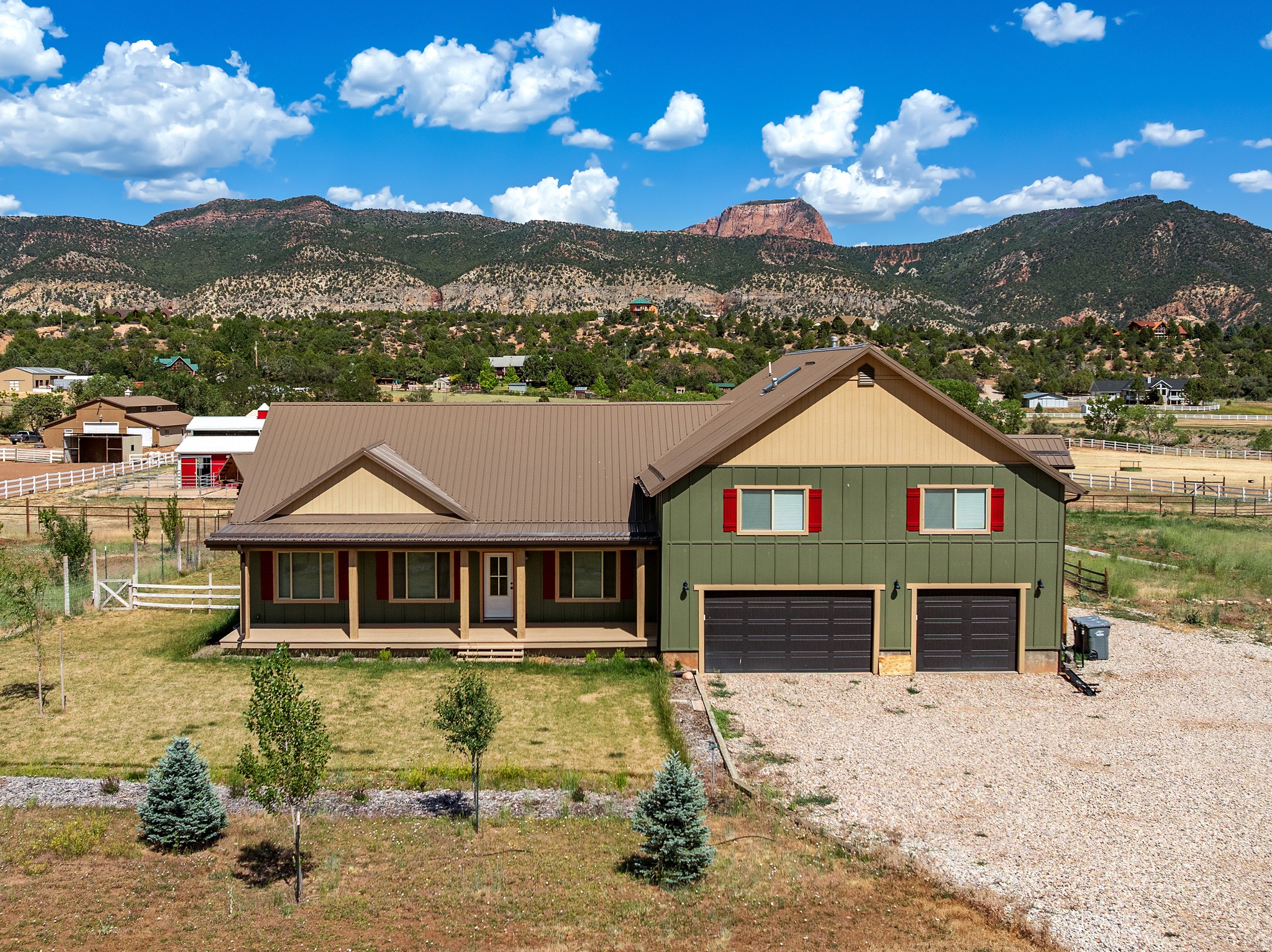 With unobstructed views of Zion's magnificent Kolob Fingers rising above the valley, this five-acre hobby farm offers a lifestyle that feels increasingly rare. Spend your evenings watching the setting sun ignite the cliffs in shades of fire and gold while horses graze peacefully beyond your window. Thoughtfully set up for western living, the property features fenced pasture, corrals, a horse barn, orchard, chicken run, and room to embrace the freedom and self-sufficiency you've been dreaming about. Open the gate, saddle up, and explore the surrounding countryside. Inside, rustic warmth meets modern comfort, while a true apartment/ADU with its own full kitchen offers flexibility for guests, family, or income potential. An unfinished basement provides a blank canvas for future expansion and customization. This is more than a home--it's a place where the view out your kitchen window becomes part of who you are.