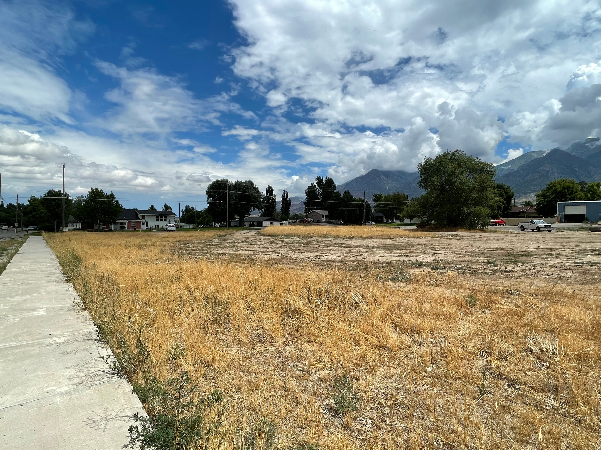 Exceptional opportunity to acquire a 1.09-acre corner parcel at the intersection of Main Street and 200 North in Mona. This highly visible and accessible property offers excellent flexibility with commercial or residential zoning, making it ideal for a variety of development opportunities. The parcel measures approximately 218' x 218' and may be subdivided into two residential lots, providing added upside for builders or investors. All major utilities are available in the road, helping streamline development. Mona is a growing rural community just south of Utah County known for its high-speed internet, clean air, and beautiful mountain and valley views, while still offering convenient access to nearby cities. The property is located just one block from the city park, approximately 2 minutes from I-15, and within easy reach of Payson (17 miles) and Nephi (8 miles). No water shares included.