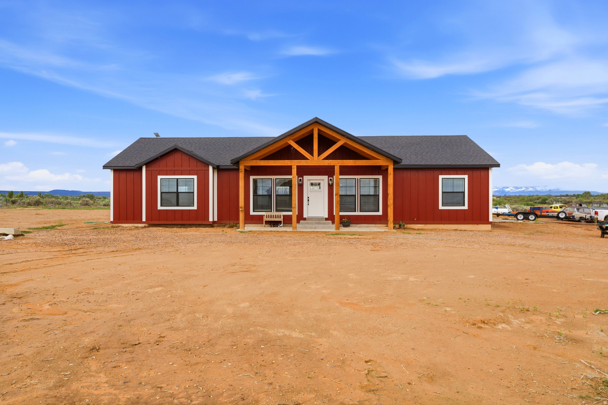 Discover the perfect blend of modern luxury and country living in this stunning 2025-built home situated on 1.22 usable acres with breathtaking open views and endless potential. This thoughtfully designed 4-bedroom, 2-bathroom home offers 1,865 sq ft of beautifully finished living space, an attached 2-car garage, and exceptional attention to detail throughout. Inside, you'll find a bright open-concept layout filled with natural light and designer finishes. The chef-inspired kitchen features custom cabinetry, quartz countertops, stainless steel appliances, open shelving, a farmhouse sink, and an oversized island perfect for entertaining. The spacious primary suite offers a spa-like retreat with a freestanding soaking tub, oversized walk-in shower, dual vanities, and radiant in-floor heating. Built with comfort and functionality in mind, the home also includes a crawlspace with additional storage, including approximately 300 sq ft beneath the primary walk-in closet with 4-foot height clearance. The property is wired for security cameras and offers power and water stubbed to both north side corners of the lot for future expansion. A massive 30x40 concrete pad is already in place for a future shop or additional building, while the partially fenced backyard area adds convenience for pets or outdoor living. Enjoy the peace of brand-new construction with room to grow, store, and create the lifestyle you've been looking for.