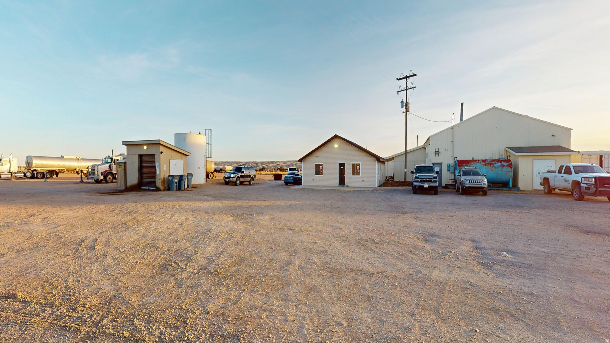 Prime 9-acre fully fenced commercial property! Office building with 2 private offices, bathroom, conference room, and  small kitchen. 5000sqft shop with heat, bathroom, and storage rooms. 2 Connex storage containers. Fuel tank & pump system.