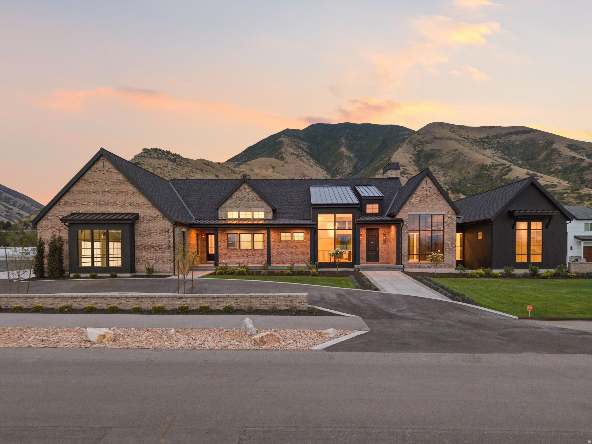 Welcome home to this stunning brand new luxury custom rambler nestled on just over an acre in Mapleton's highly sought after Wren Meadows subdivision. The home offers 4 bedrooms, 5 full baths, and 1 half bath, surrounded by gorgeous mountain views. The beautiful gourmet kitchen features quartz countertops, custom cabinetry, high end lighting, GAS LANTERNS, and designer finishes that carry throughout the entire home. The main level includes a spacious great room with large sliding glass doors that open to the covered deck, a den and office, a main level primary suite with a large walk in closet, and a dedicated 1400 sqft gym complete with a DRY sauna, STEAM ROOM, and cold plunge. Radiant heated floors run throughout the home, keeping it warm and comfortable through every Utah season. RADIANT SNOW MELT DRIVEWAY, NO MORE SHOVELING SNOW. The fully finished basement is designed for fun and relaxation, featuring 4 bedrooms, a kitchenette, a living room, and a state of the art theater room perfect for movie nights and game days. Set on just over an acre, the backyard offers unobstructed mountain views and outstanding privacy. Two covered patios, a fully landscaped front yard, and a five car garage that is as impressive as the rest of the home complete this incredible property. Why spend years designing and building when you can move right into this extraordinary home and start enjoying it today. Schedule your private showing and come experience one of the finest homes on the market in Utah County.