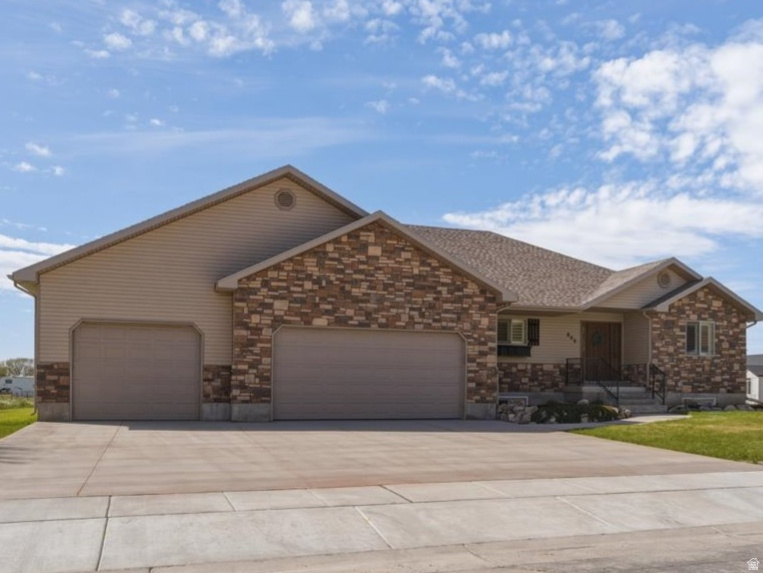 Spacious, beautifully maintained, and thoughtfully designed, this 6-bedroom, 3.5-bath home sits on a generous .46-acre lot and offers the perfect blend of comfort, functionality, and room to grow. Built with 2x6 construction for enhanced insulation and efficiency, this home has been exceptionally well cared for and shows pride of ownership throughout.  The main level features a desirable primary suite for easy living, along with a well-appointed kitchen complete with double ovens, a gas cooktop, and plenty of prep space-perfect for entertaining or everyday meals. With multiple living areas and six bedrooms, there's space for everyone to spread out and feel at home.  Car enthusiasts, hobbyists, or anyone needing extra storage will love the oversized 3-car garage, featuring an extra-deep third stall with built-in workbench and cabinetry, plus 220V power for added versatility.  Step outside to the expansive backyard where you'll find plenty of room to relax, play, or entertain-including a cozy firepit area, perfect for evenings under the stars. The large lot offers endless possibilities while still feeling private and usable.  This is a rare opportunity to own a meticulously maintained home with space, quality construction, and features that truly set it apart.