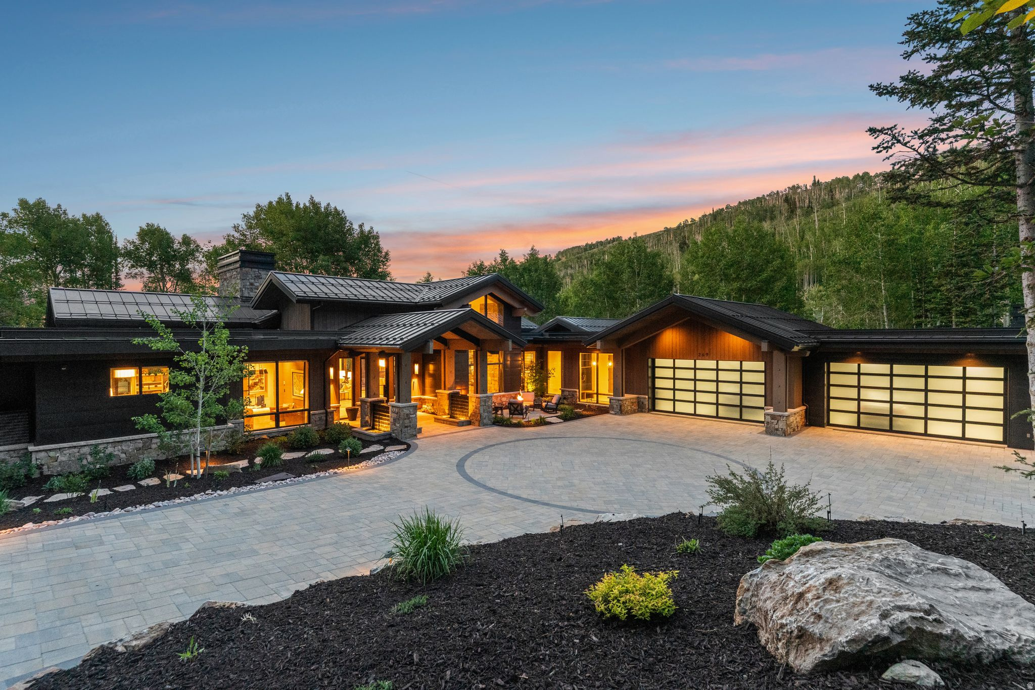Perfectly positioned on one of the premier homesites in Phase 5 of The Colony at White Pine Canyon, this recently completed mountain estate offers over 11,000 square feet of thoughtfully designed living space, exceptional ski-in/ski-out access, and breathtaking views of the upper meadow, lakes, surrounding ski slopes, and the Wasatch Mountains. The main level features a dramatic great room with soaring ceilings, a chef's kitchen, wet bar, coffee bar, wine room, hearth room, private office, luxurious primary suite, and guest suite, all opening to expansive heated outdoor living spaces. Designed for recreation and entertaining, the lower level includes a spacious family room with a full bar, golf simulator, billiards area, fitness center, steam room, and four additional bedroom suites, including a custom bunk room. Finishes throughout reflect a refined mountain aesthetic, highlighted by hardwood flooring, rift oak cabinetry, natural stone accents, designer fixtures, smart home technology, and an abundance of comfort-focused amenities. Heated patios and decks, an outdoor kitchen, multiple fire features, and beautifully landscaped grounds create seamless indoor-outdoor living year-round. Ideally located along Colony Way, owners enjoy effortless ski access directly to the Flat Iron Chairlift with convenient ski-in access from the Quicksilver Gondola. During the summer months, scenic trails, lakes, waterfalls, and countless recreational opportunities are just outside the door. Offering an extraordinary combination of privacy, views, recreation, and luxury, this is a rare opportunity to own one of The Colony's finest residences.