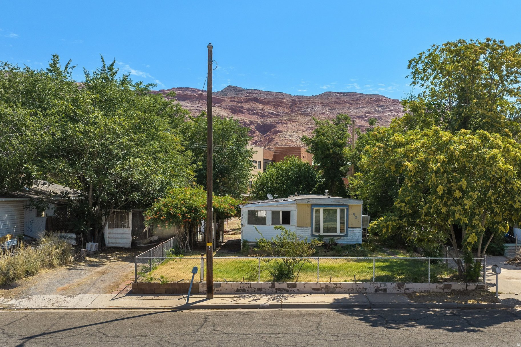 Prime downtown Moab lot offering exceptional redevelopment potential! Conveniently located near Main Street, schools, the hospital, city park, and aquatic center. The property includes an older mobile home in need of significant repair or replacement. Whether you're looking for an investment, renovation project, or future building site, this is a rare opportunity to own property in downtown Moab.