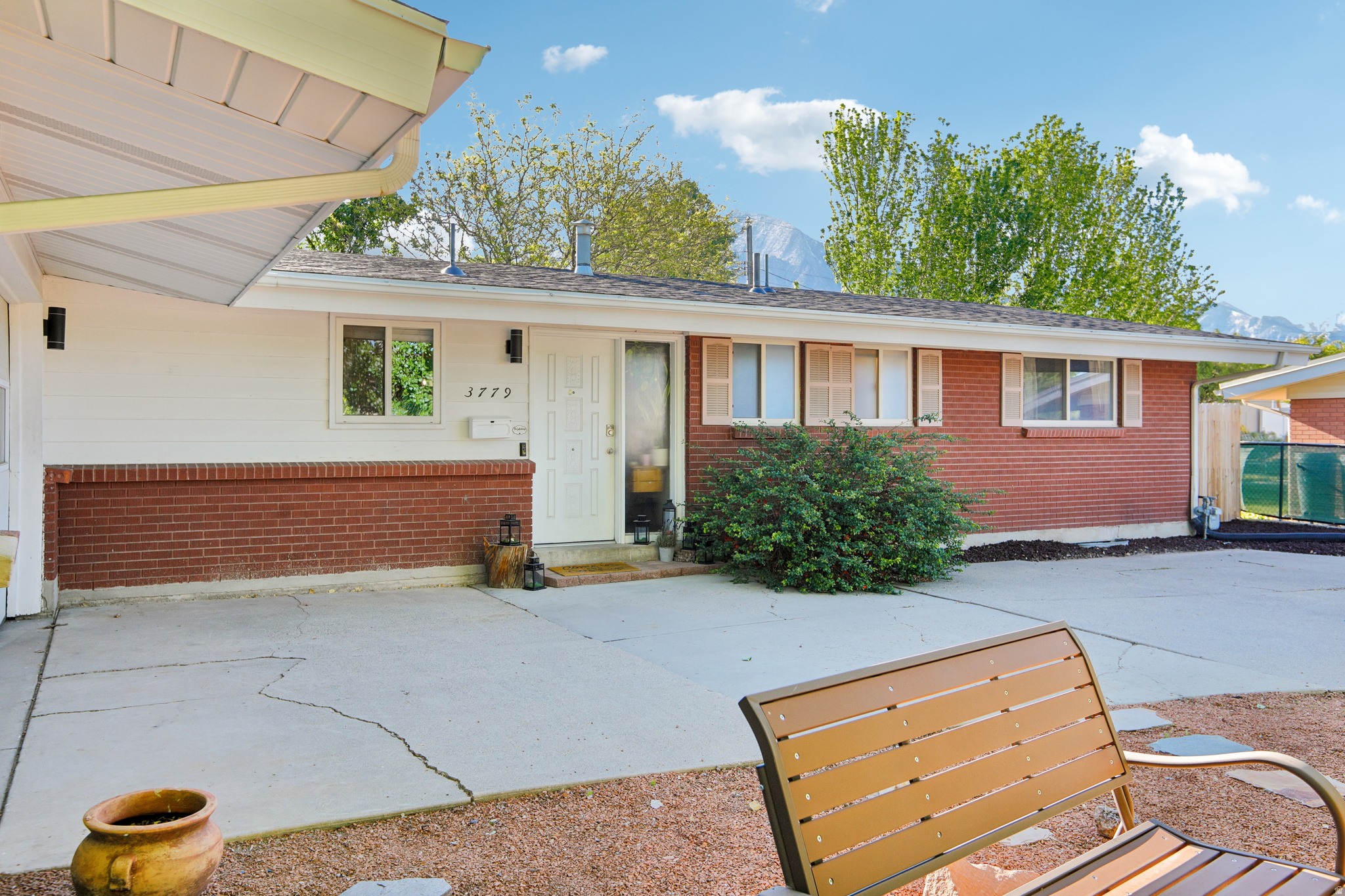 Charming Millcreek Rambler with Stunning Mountain Views! Welcome home to this beautifully designed rambler nestled on a spacious almost quarter-acre lot in the highly desirable Millcreek neighborhood. The main floor boasts hardwood floors throughout with a bright, open-concept kitchen and family room perfect for gathering, alongside a private primary bedroom featuring newly repaired hardwood floors, a walk-in closet, and an ensuite bath, plus an additional bedroom and a full bath. Head downstairs to find a versatile, finished basement featuring a second living area, two more bedrooms, a full bath, a convenient kitchenette, an abundance of storage space-great for a possible guest or mother-in-law suite-and a finished-off ceiling, with the sellers fully completing the installation of the durable LVP flooring prior to closing. The outdoor living is second to none with a private, fully fenced backyard complete with a covered patio, a lush grassy lawn, and breathtaking mountain views perfect for summer entertaining, plus bonus features including an attached 2-car garage and a massive driveway with parking for an RV and 4+ vehicles.