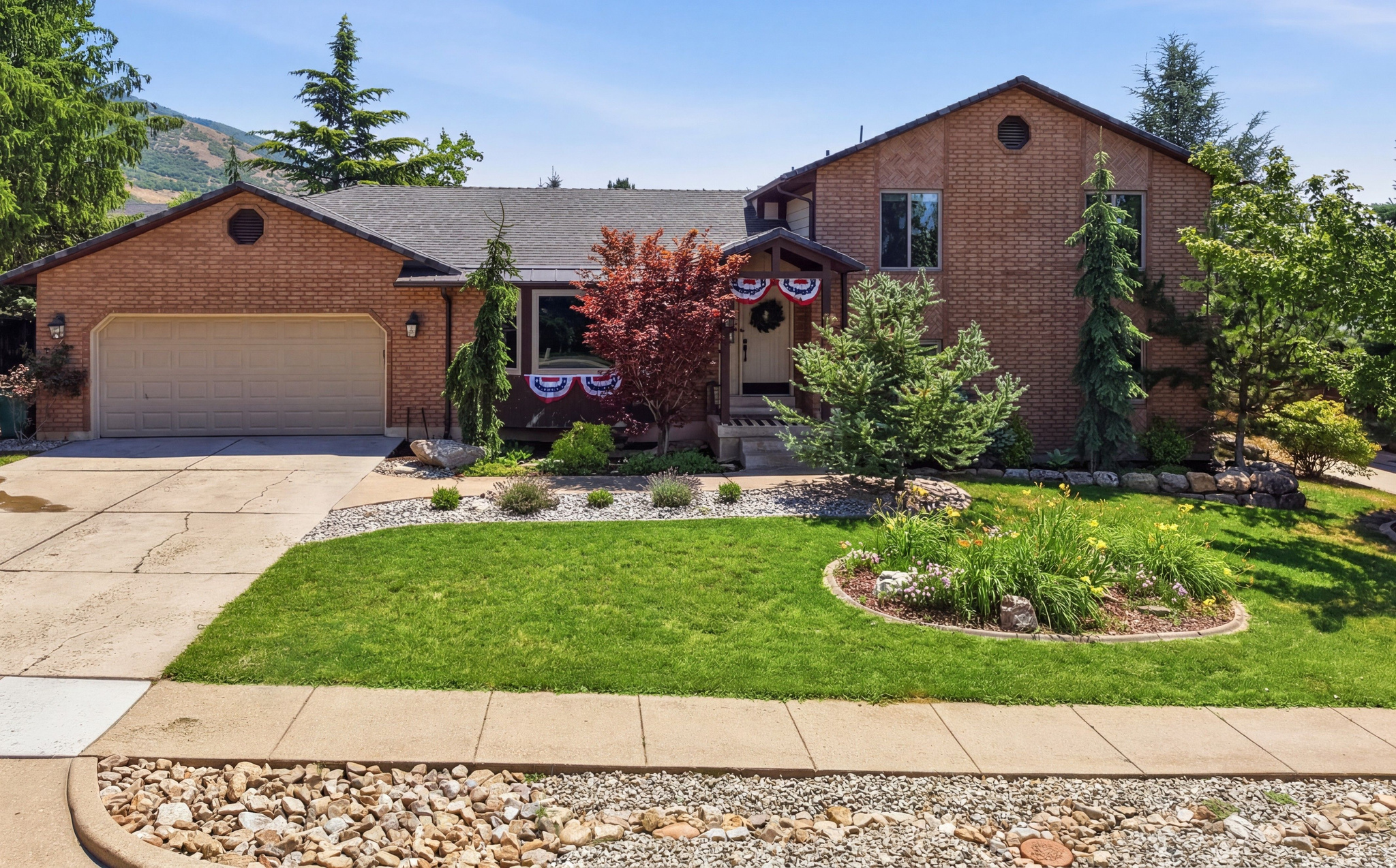 ***TO BE FEATURED ON ABC 4 REAL ESTATE ESSENTIALS*** Welcome to one of East Layton's most impressive homes. Every inch of this property has been thoughtfully elevated with high-end finishes, timeless design, and major system upgrades that are nearly impossible to find at this price point.  The heart of the home is a true chef's kitchen featuring premium WOLF appliances, a built-in Thermador refrigerator, stunning quartzite countertops, a dramatic waterfall island, pot filler, custom beverage station, and designer finishes that make this space as functional as it is beautiful. Whether you're hosting holidays or enjoying a quiet evening at home, this kitchen was built to impress.  Natural wood accents, quality craftsmanship, and abundant natural light create a warm, sophisticated feel throughout the home. The spacious primary suite offers its own private balcony overlooking the mature landscape and mountain views, creating the perfect place to start or end your day.  The updates extend far beyond cosmetics with a new roof, new windows, updated electrical panel, tankless water heater, high-efficiency furnace and air conditioner, EV charging, gas connection for a future garage heater, and water softener-giving buyers confidence that the expensive projects have already been completed. Enjoy your home-grown produce and fruit trees in the privacy of your backyard oasis. Situated on a quiet East Layton street surrounded by mature landscaping, this home offers privacy, incredible mountain views, and pride of ownership at every turn. Luxury finishes. Designer details. Major mechanical upgrades. This is the one buyers have been waiting for!!  Square footage figures are provided as a courtesy estimate only. Buyer is advised to obtain an independent measurement.